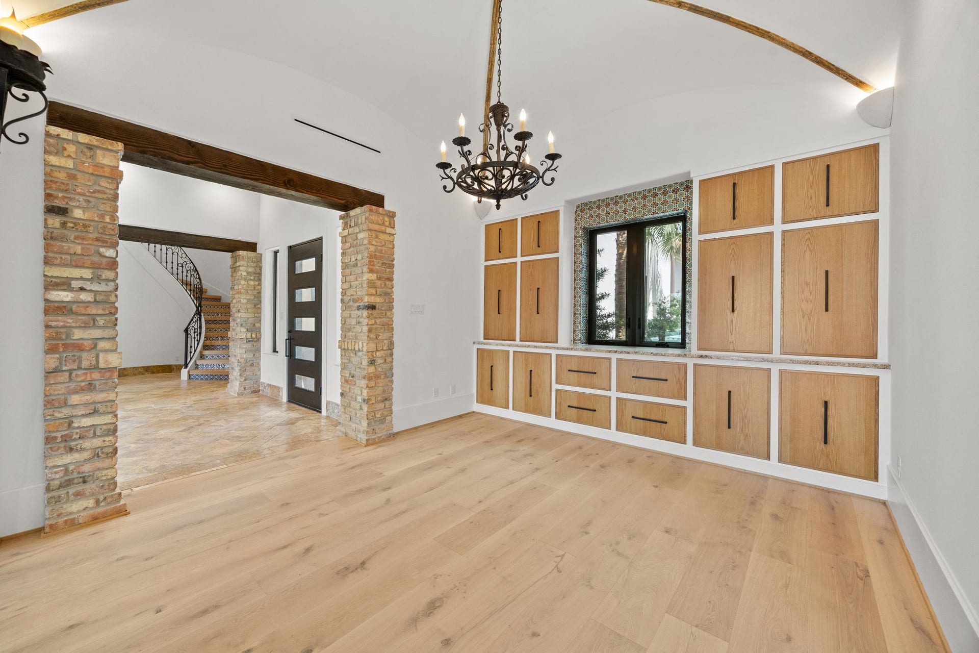 721 Harborside Way, League City, TX 77565 The elegant dining room showcases custom built-in cabinetry and a dramatic arched ceiling, creating a sophisticated setting for both intimate dinners and grand entertaining.