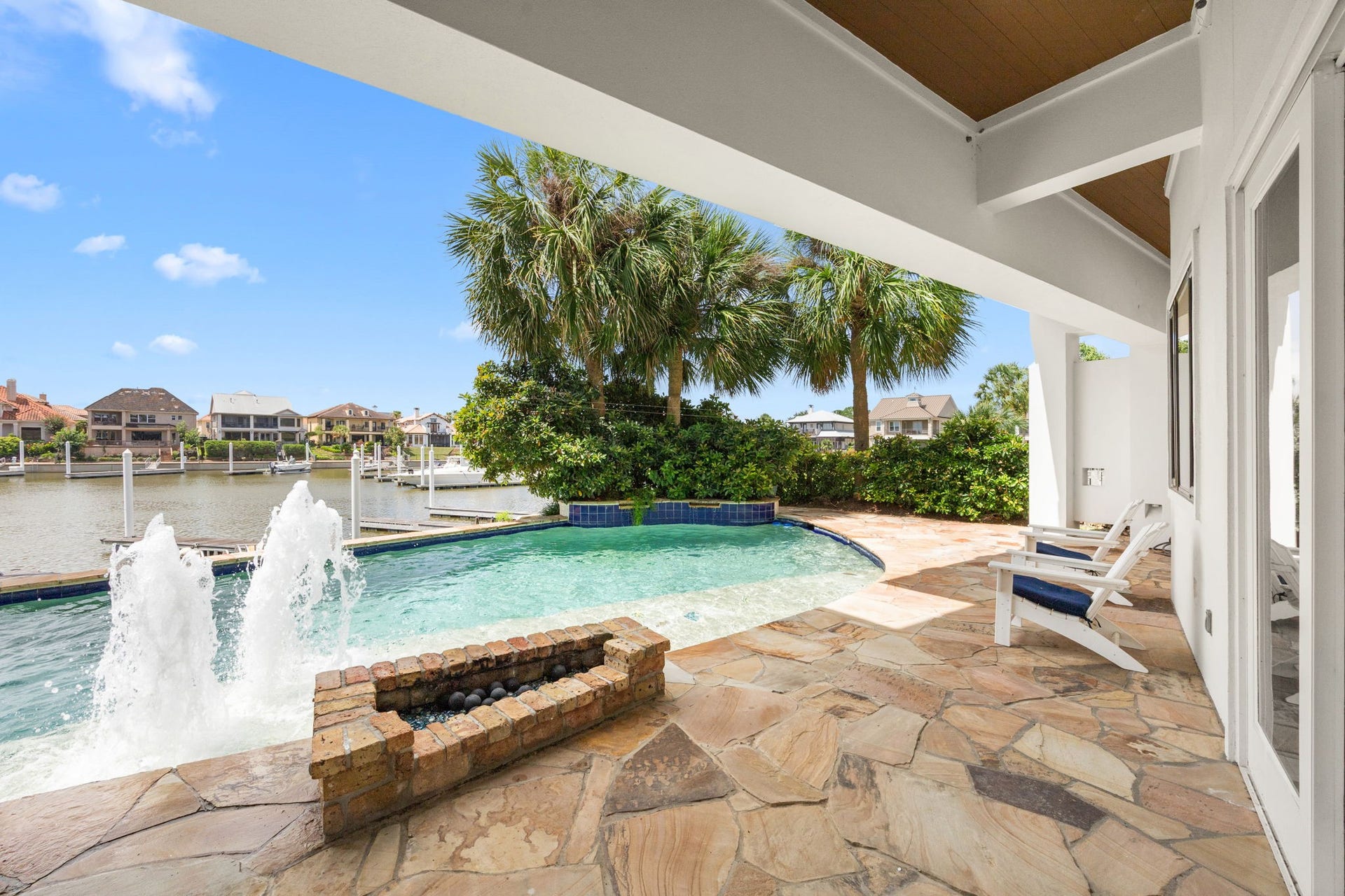 721 Harborside Way, League City, TX 77565 The resort-style pool is enhanced by grand fountains and a dramatic waterfall, creating a stunning backyard oasis.