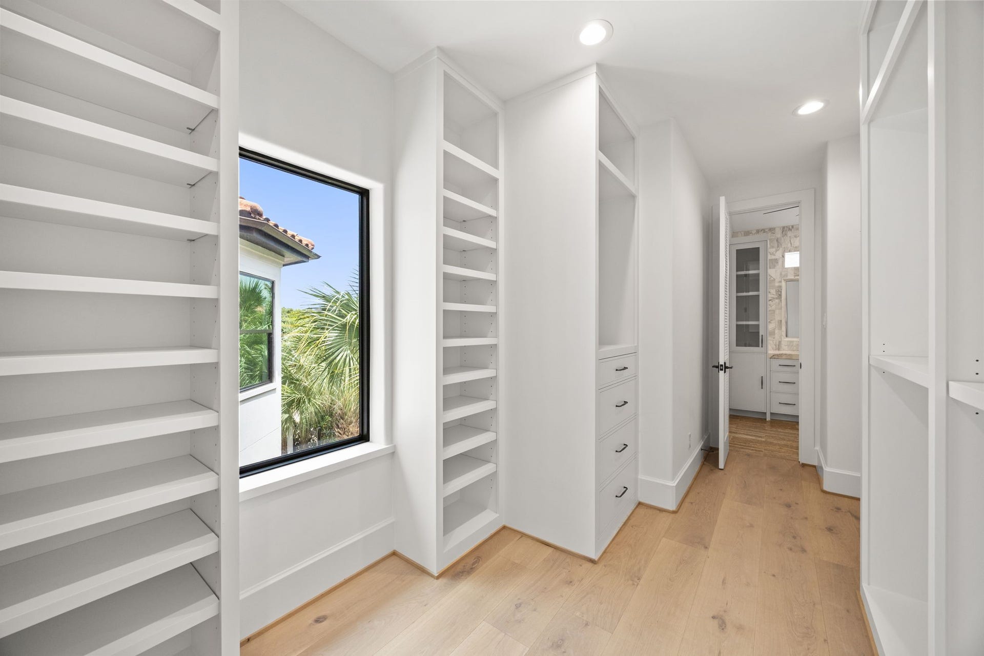 721 Harborside Way, League City, TX 77565 The upstairs primary closet offers abundant custom shelving and cabinetry, providing exceptional organization and storage.