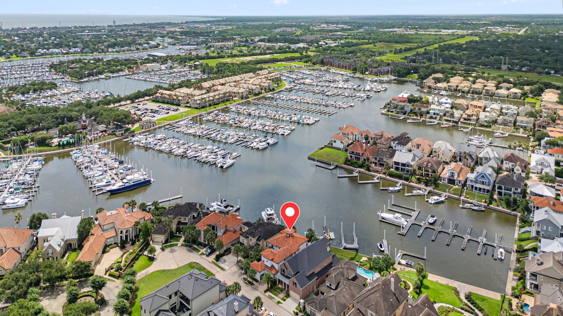 721 Harborside Way, League City, TX 77565 Aerial view of the home and private marina showcasing its premier waterfront setting and exceptional location.