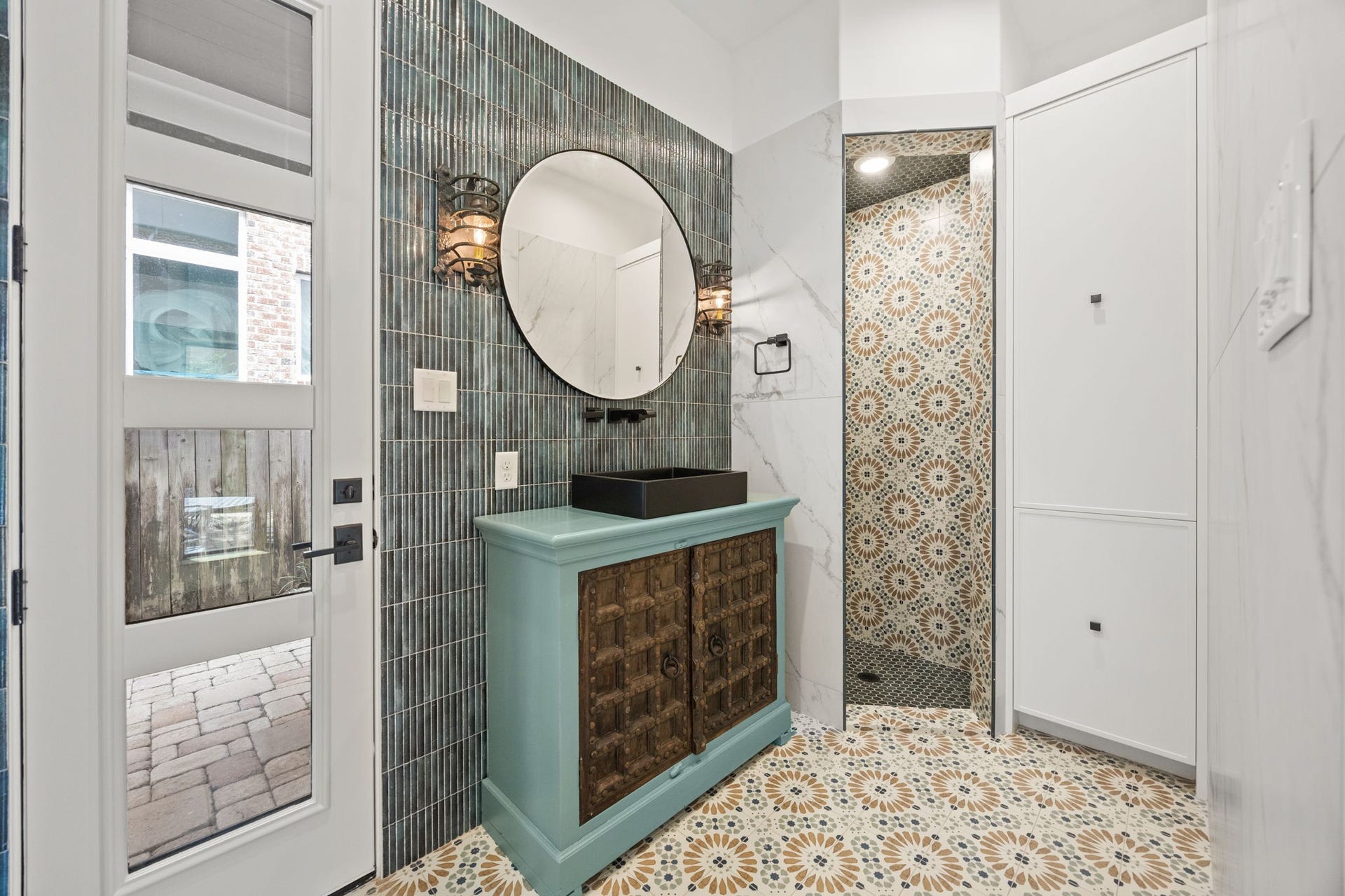 721 Harborside Way, League City, TX 77565 The full cabana bath is beautifully accented throughout and includes an exterior door with direct access to the pool, enhancing convenience for resort-style living.