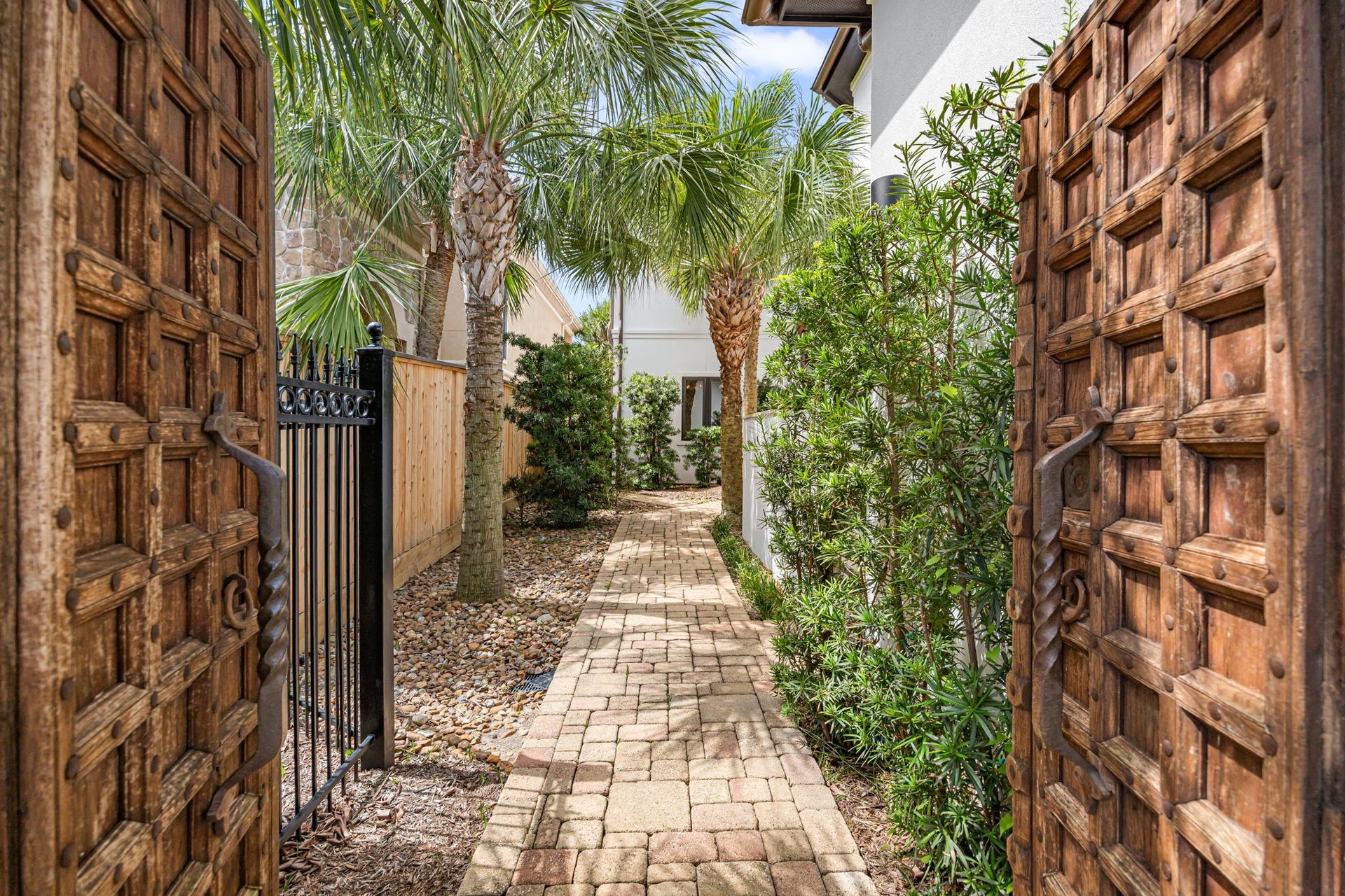 721 Harborside Way, League City, TX 77565 A resort-style entry welcomes you through stunning antique wood doors, setting the tone for the homes timeless elegance.