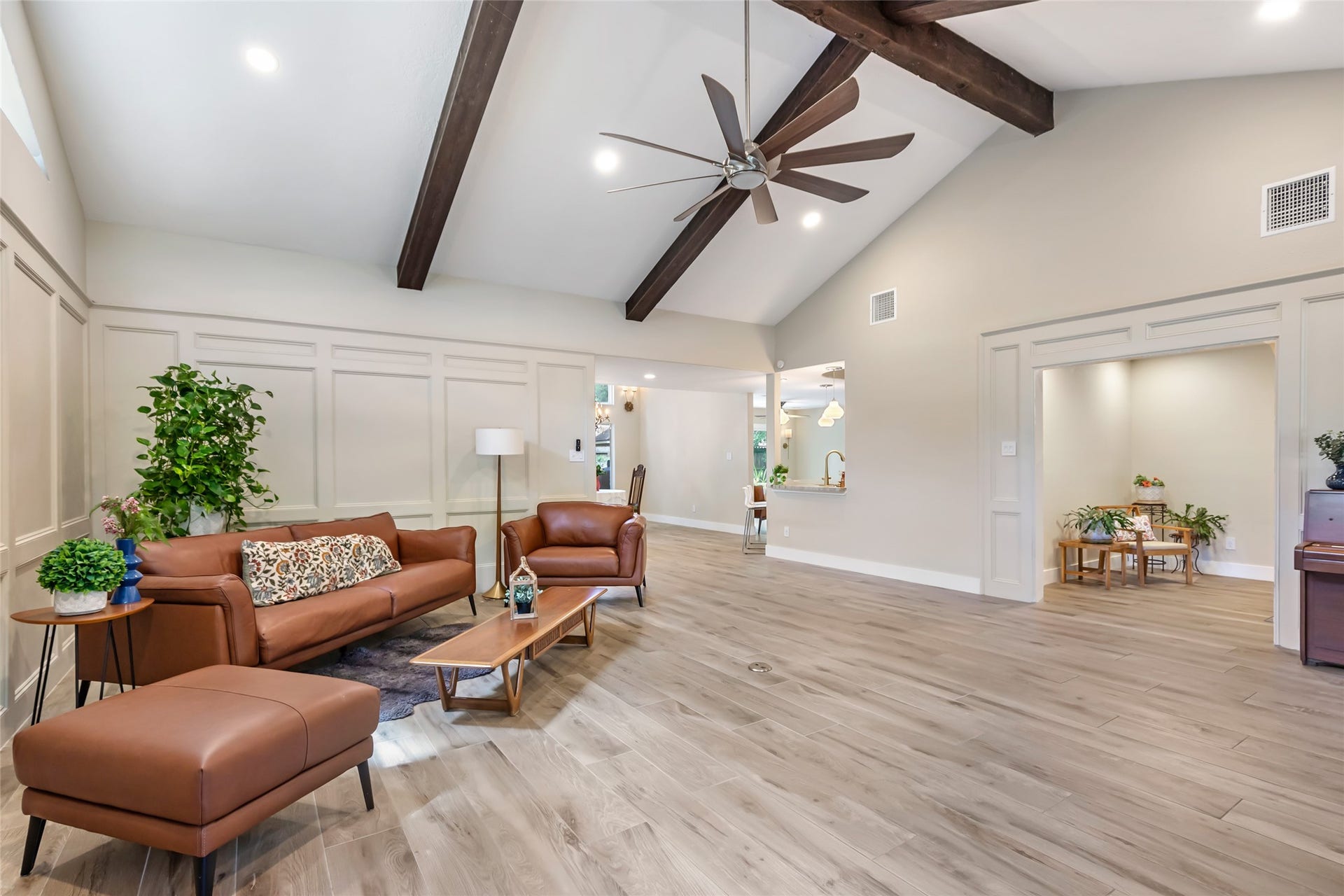3714 Swift Creek Drive, Kingwood, TX 77339 Spacious living area with vaulted ceilings, exposed beams, and elegant and durable ceramic wood flooring.