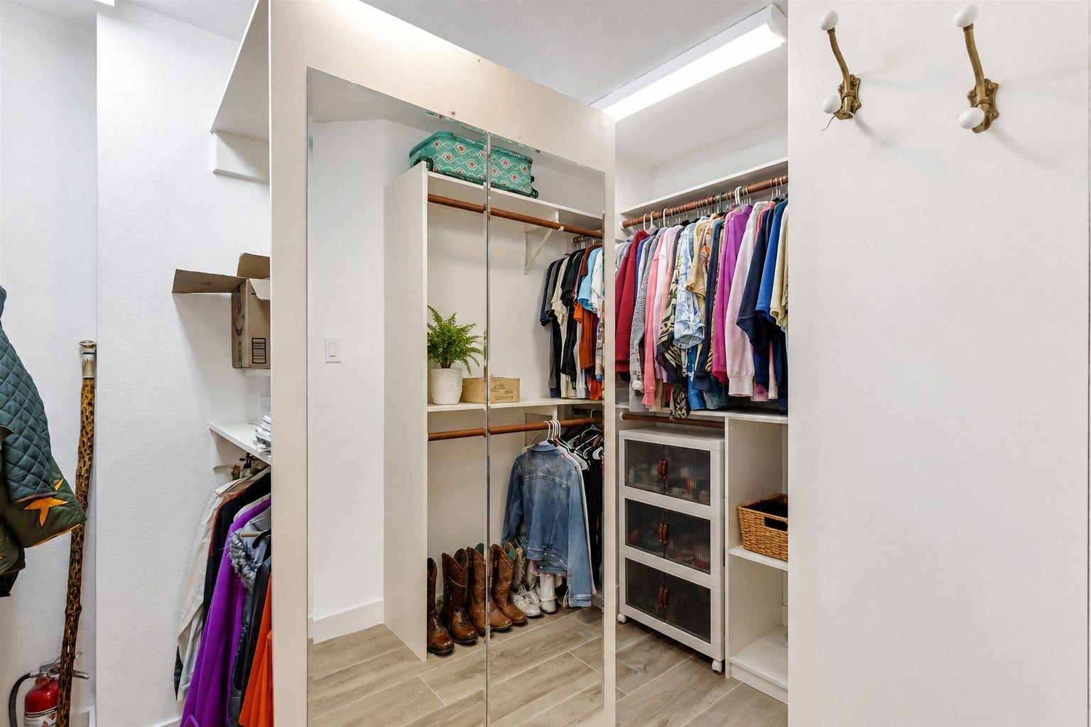 3714 Swift Creek Drive, Kingwood, TX 77339 Primary bedroom closet has a pass through cabinet to conveniently throw dirty clothes directly into the washer!