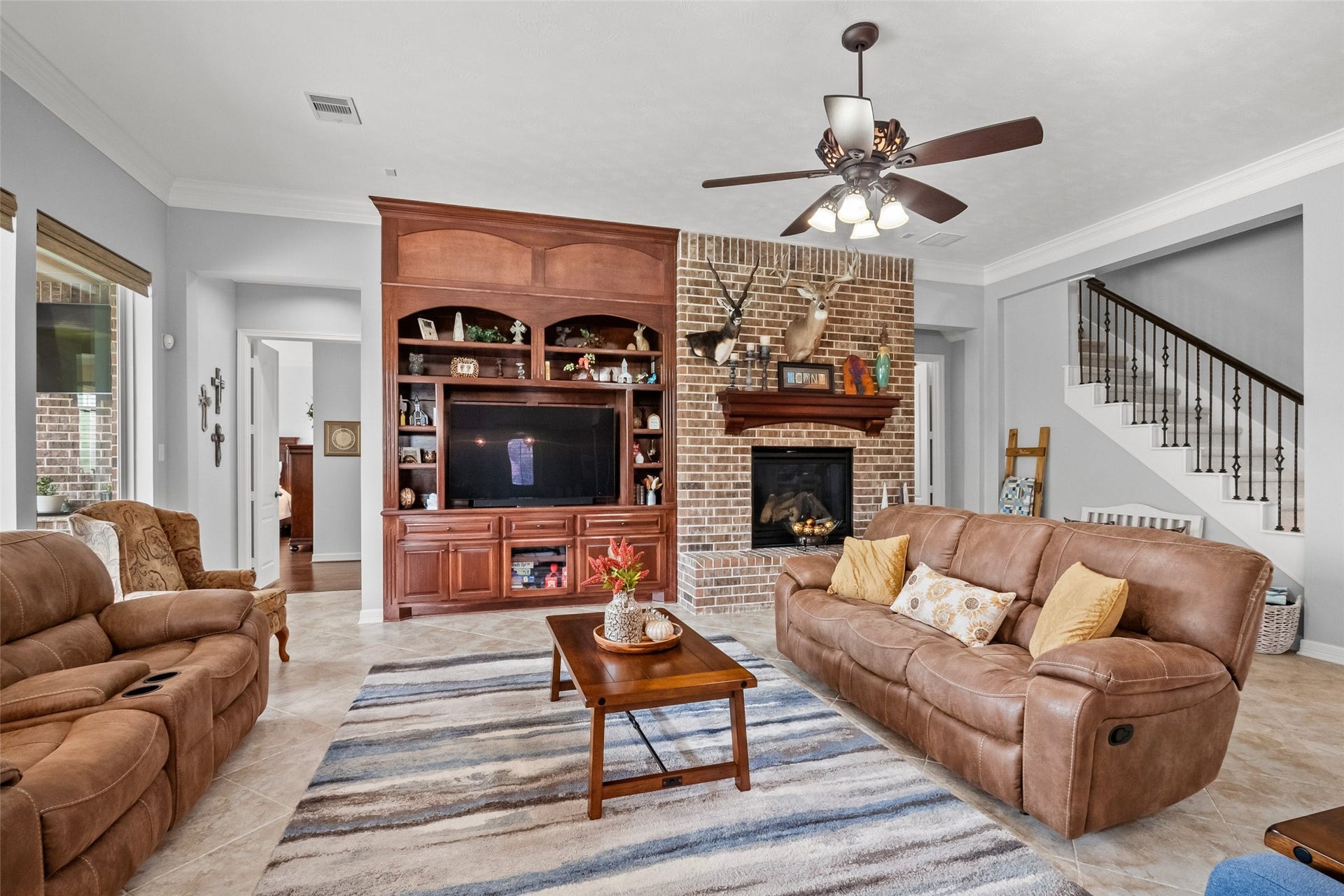 21114 W Kelsey Creek Trail, Cypress, TX 77433 Living room with a partial view of the stairs leading up to the gameroom, 1/2 bath & closet upstairs. There is also a door to enter the floored space of the attic.