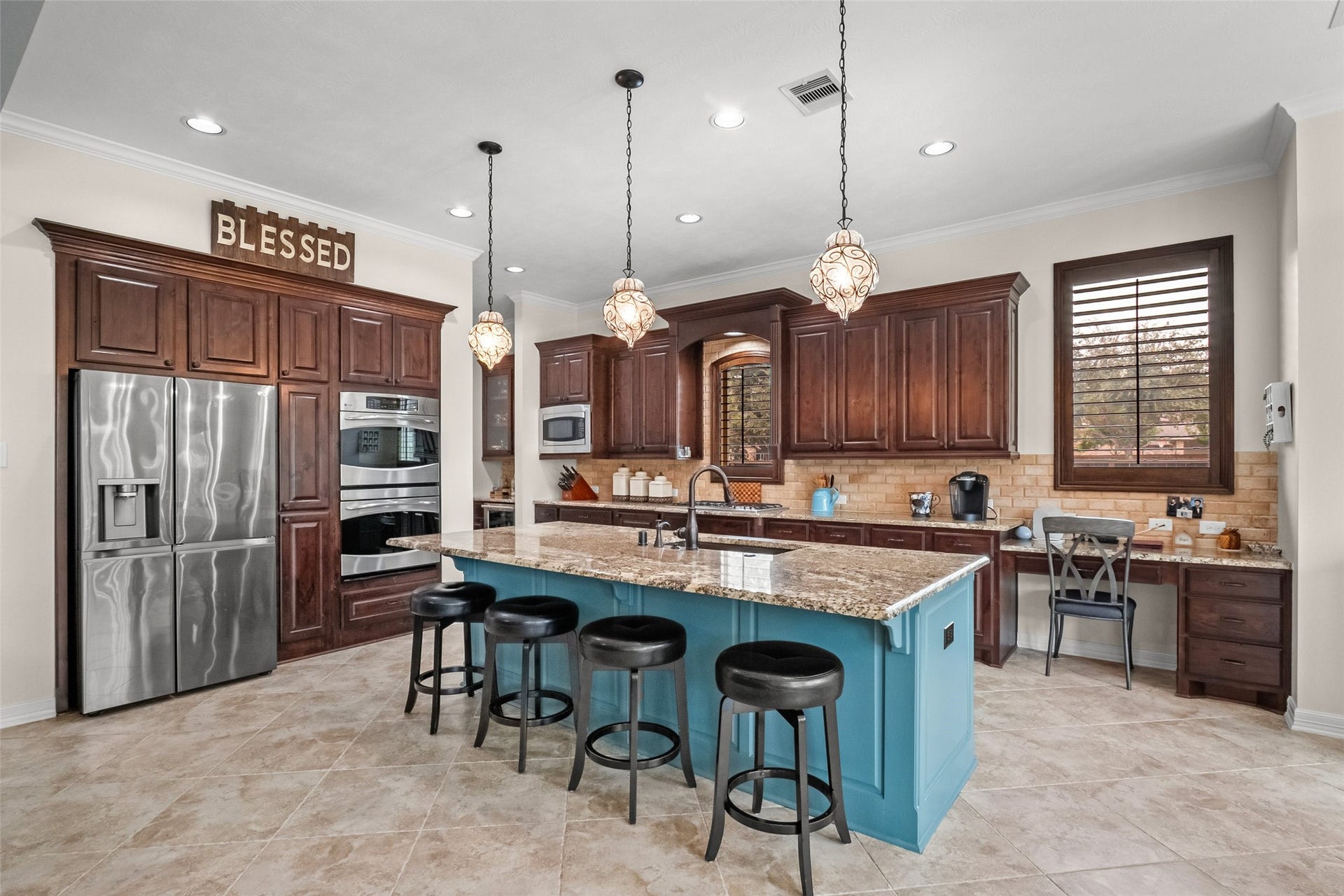 21114 W Kelsey Creek Trail, Cypress, TX 77433 Kitchen island comfortably holds 4 barstools. Double convection ovens, cooktop has pop-up exhaust ventilation, and there is even a chef's desk. This desk is a great place for a child to do homework while under a watchful eye.