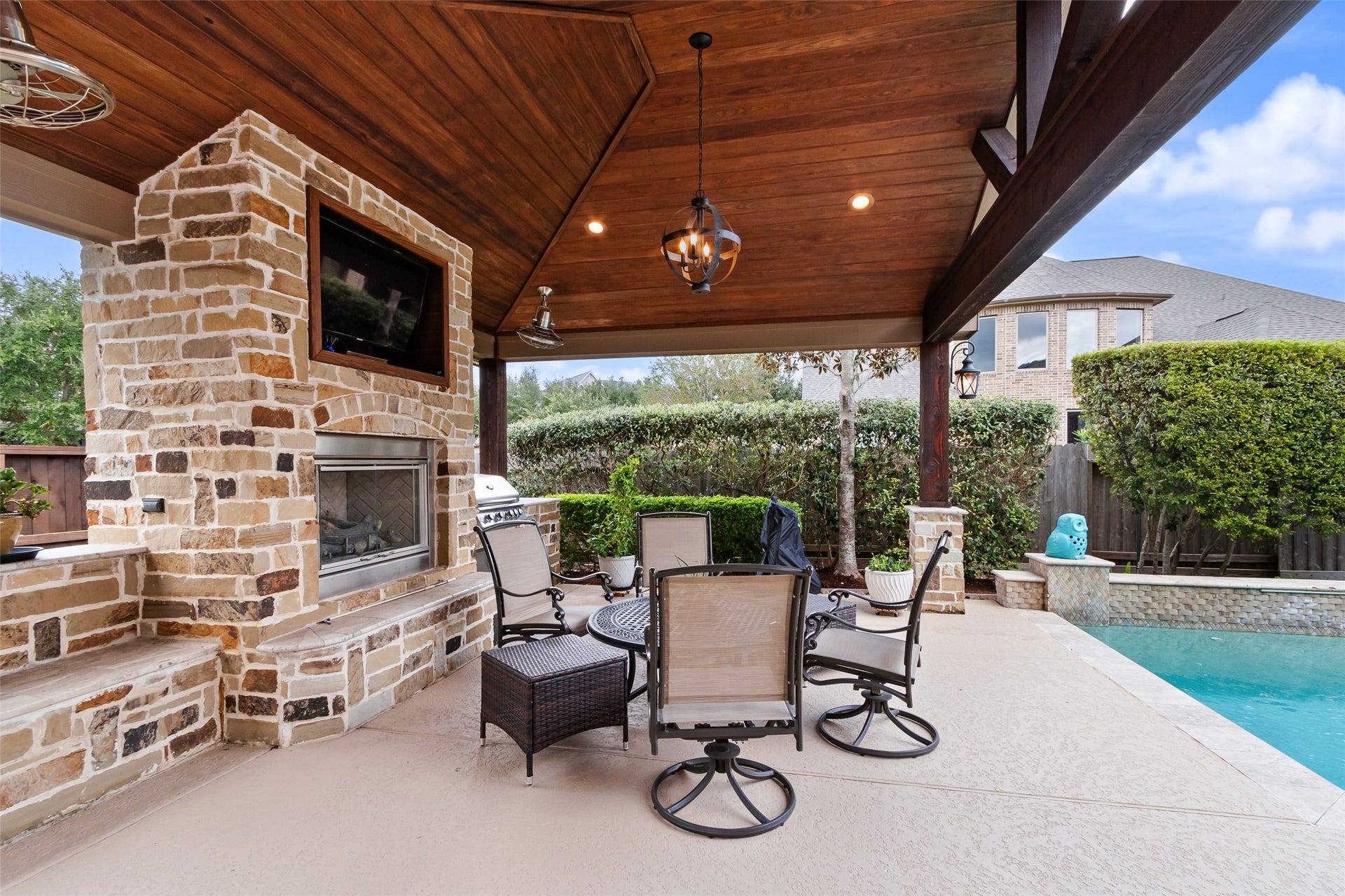 21114 W Kelsey Creek Trail, Cypress, TX 77433 Pergola fully covered with a gas log fireplace & outdoor kitchen that includes a built-in gas grill. Gather around the fireplace for a football game or cook a meal while swimming in the summertime. This outdoor space flows seamlessly between the seasons.