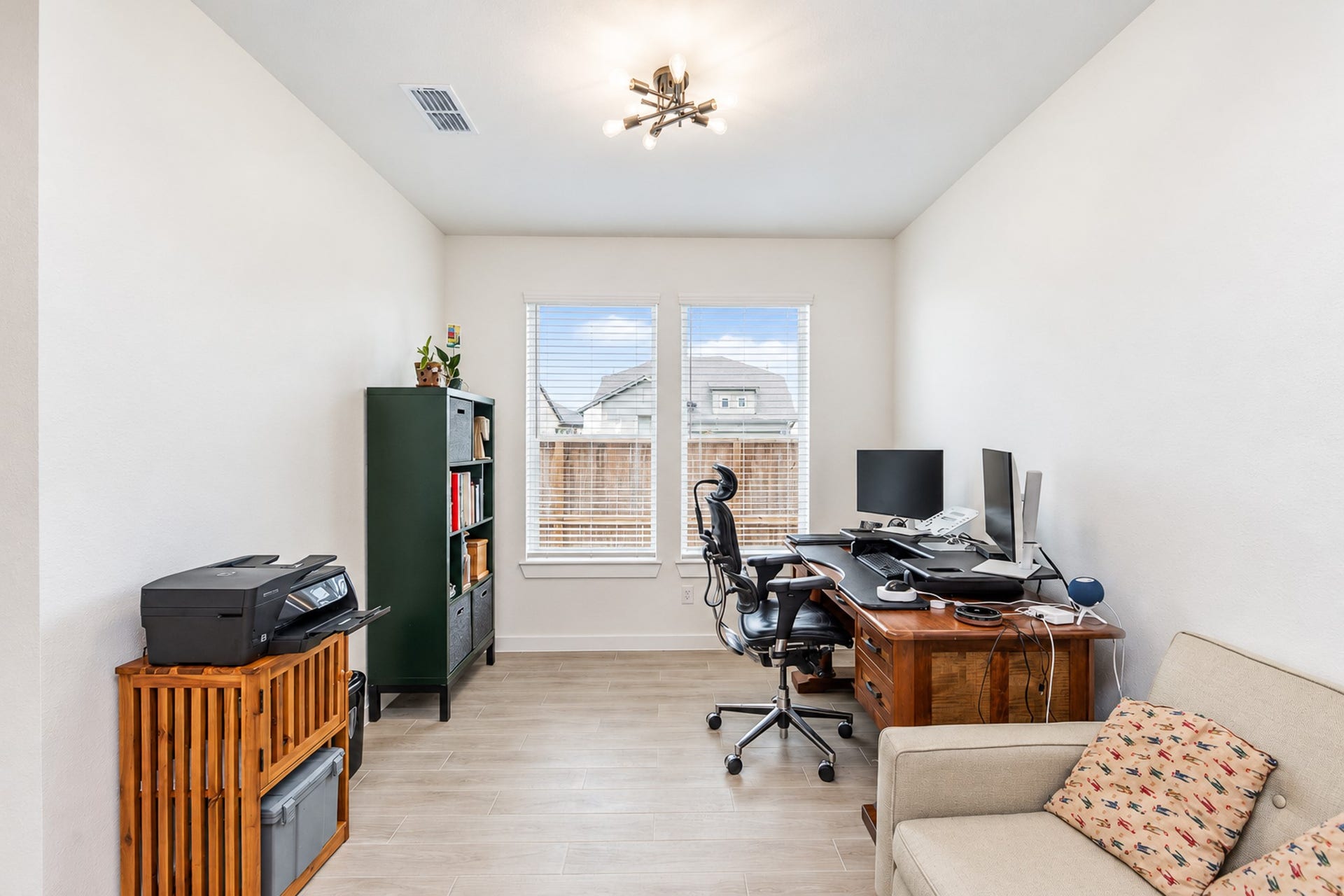 16922 Warm Glow Court, Hockley, TX 77447 Bright and functional home office featuring large windows, sleek flooring, and ample space for work essentials.