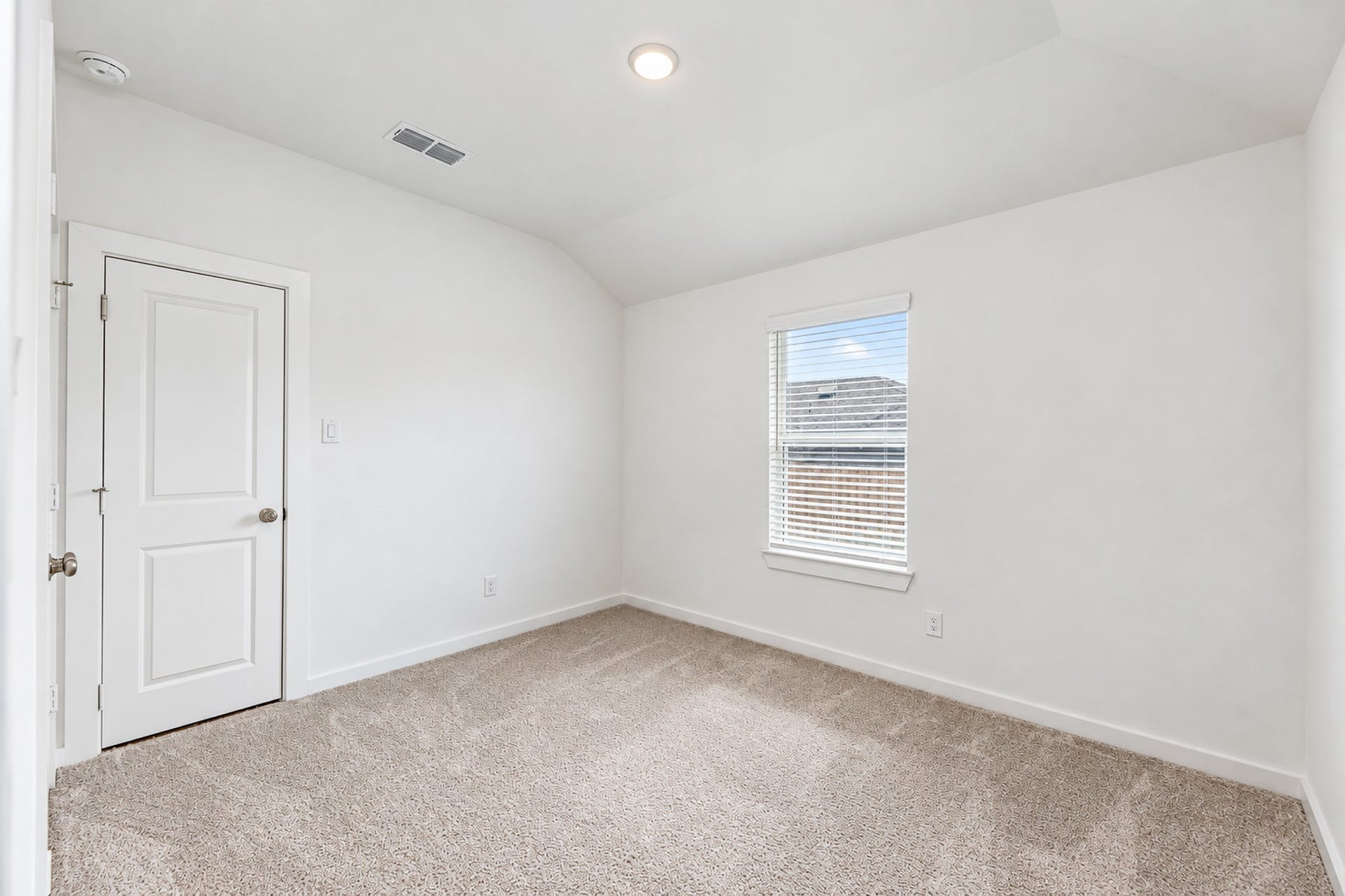 16922 Warm Glow Court, Hockley, TX 77447 Cozy and bright bedroom with soft carpeting, a large window for natural light, and a classic white door.