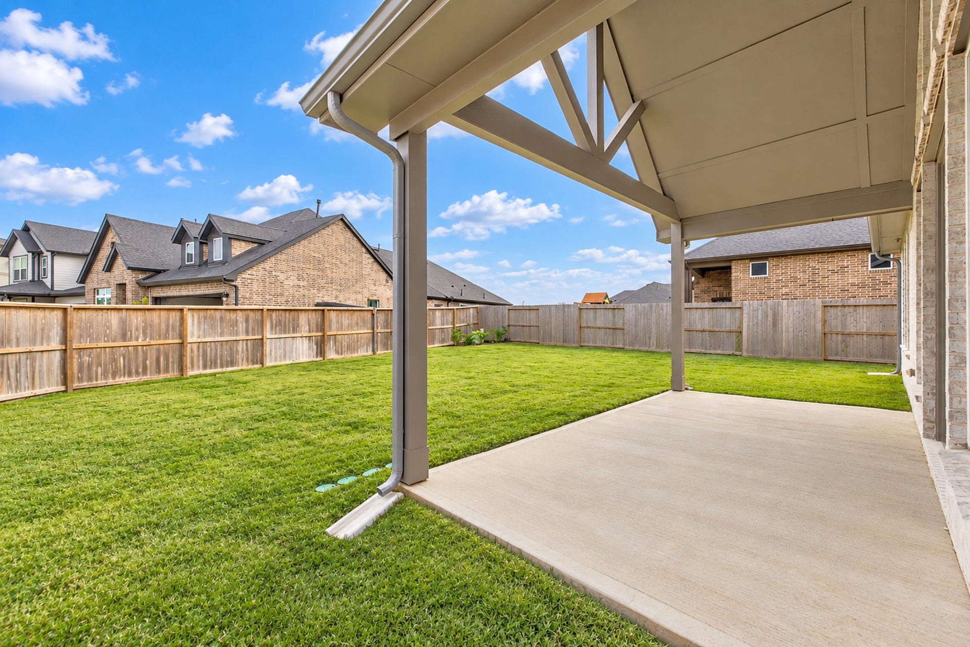 16922 Warm Glow Court, Hockley, TX 77447 Spacious backyard with a covered patio, perfect for outdoor relaxation and entertaining, surrounded by a privacy fence.