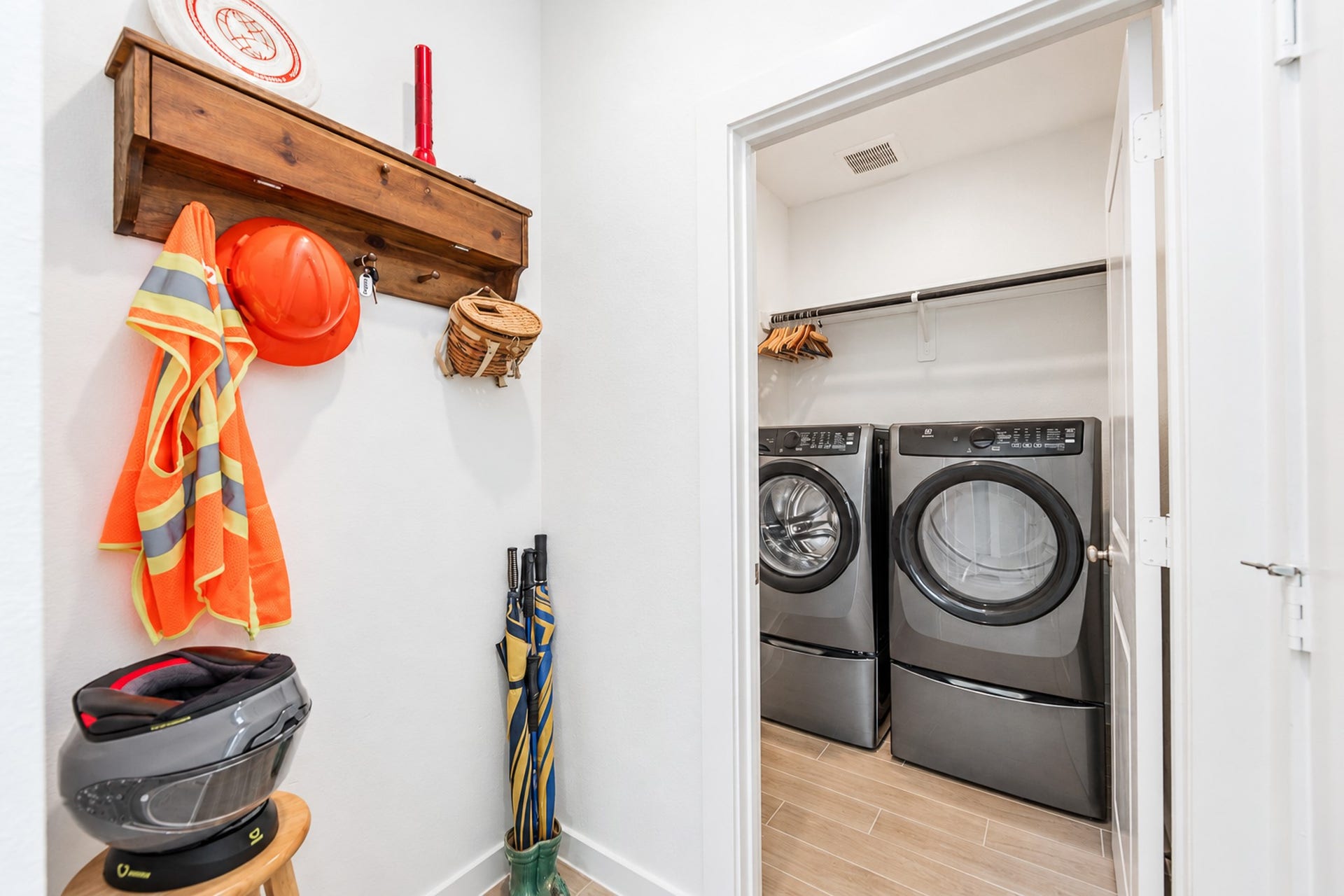 16922 Warm Glow Court, Hockley, TX 77447 Conveniently designed laundry area with modern washer and dryer, ample storage, and space for organizing outerwear and accessories.
