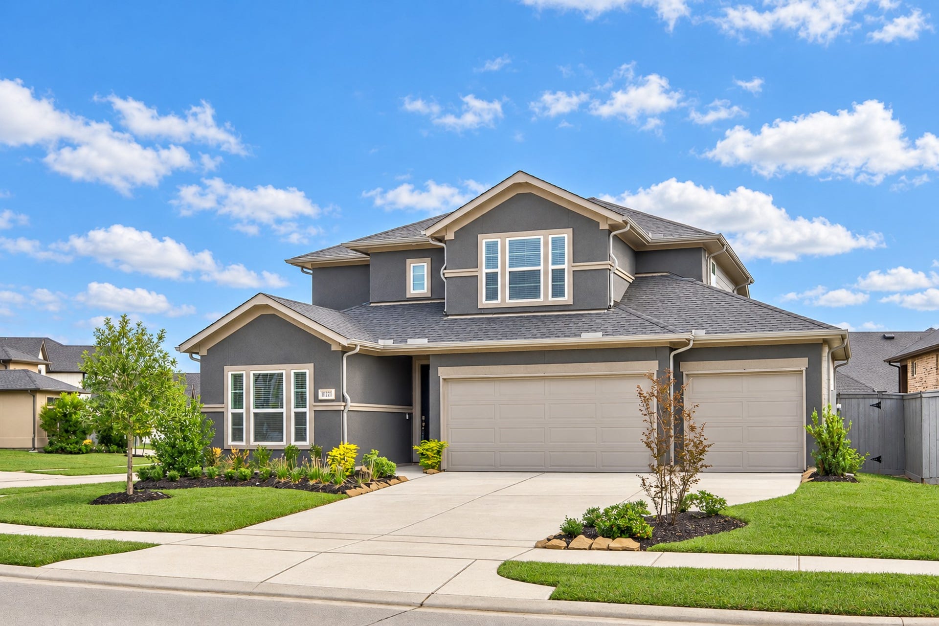 16922 Warm Glow Court, Hockley, TX 77447 Charming two-story home with a modern exterior and spacious three-car garage, set on a well-maintained corner lot with lush landscaping.