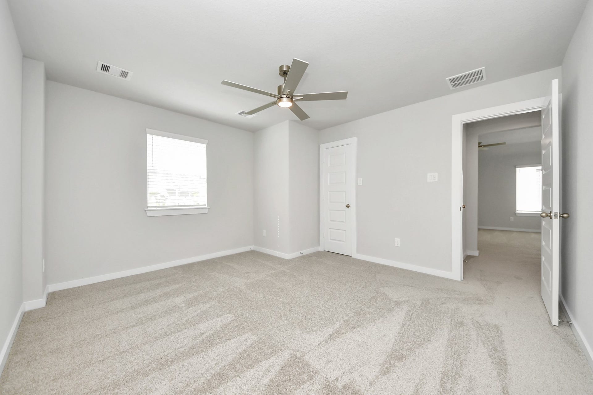11103 Tulip Ridge Trail, Houston, TX 77044 Generously sized secondary bedrooms featuring spacious closets, soft and inviting carpeting underfoot, large windows allowing plenty of natural light, and the added touch of privacy blinds for your personal retreat. Sample photo of completed home with similar floor plan. Actual colors and selections may vary.