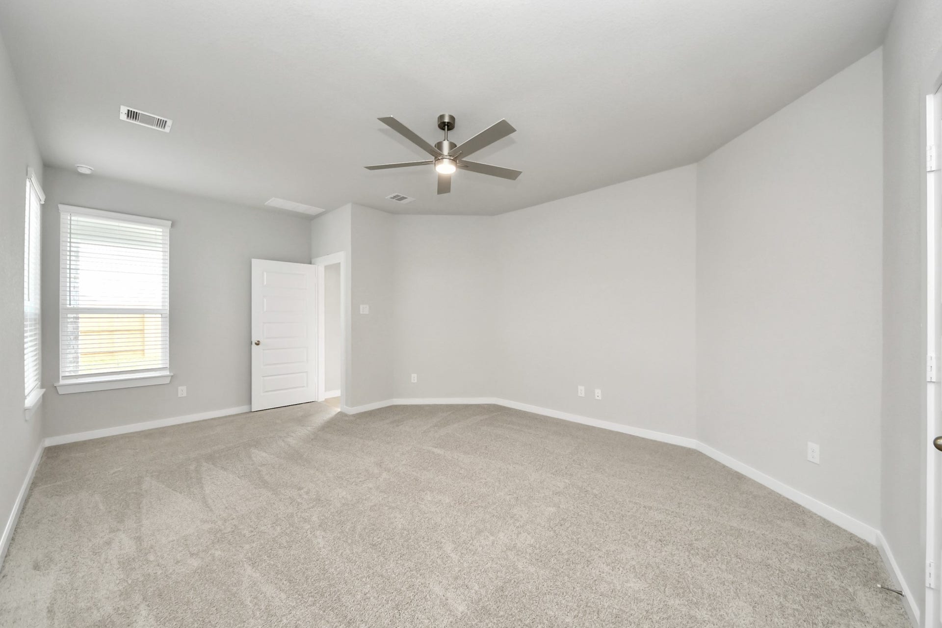 11103 Tulip Ridge Trail, Houston, TX 77044 Come and unwind after a long day in this magnificent primary suite! This spacious room features plush carpet, warm paint, high ceilings and large windows with privacy blinds. Sample photo of completed home with similar floor plan. Actual colors and selections may vary.
