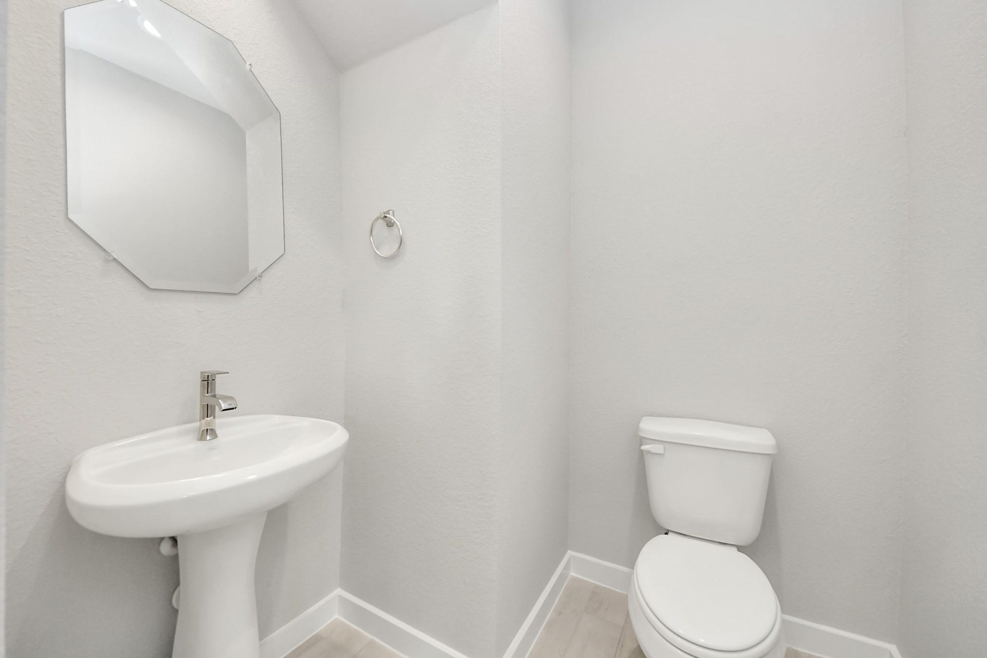11103 Tulip Ridge Trail, Houston, TX 77044 This half bathroom features a stylish pedestal sink, modern hardware, and bright recessed lighting, creating a sleek and inviting space. Sample photo of completed home with similar floor plan. Actual colors and selections may vary.
