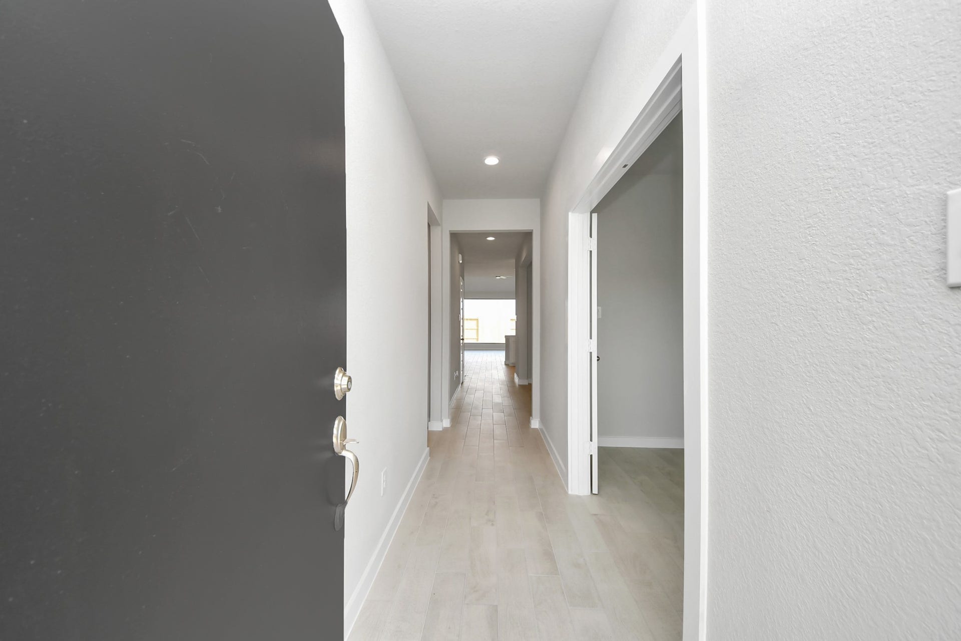 11103 Tulip Ridge Trail, Houston, TX 77044 As you step into the threshold of this luxurious home, you'll soon be welcomed by an elegant glass door (to be installed). Inside, soaring ceilings amplify the spaciousness, while the refined wood-look tile flooring and oversized baseboards exude sophistication and charm. Sample photo of completed home with similar floor plan. Actual colors and selections may vary.