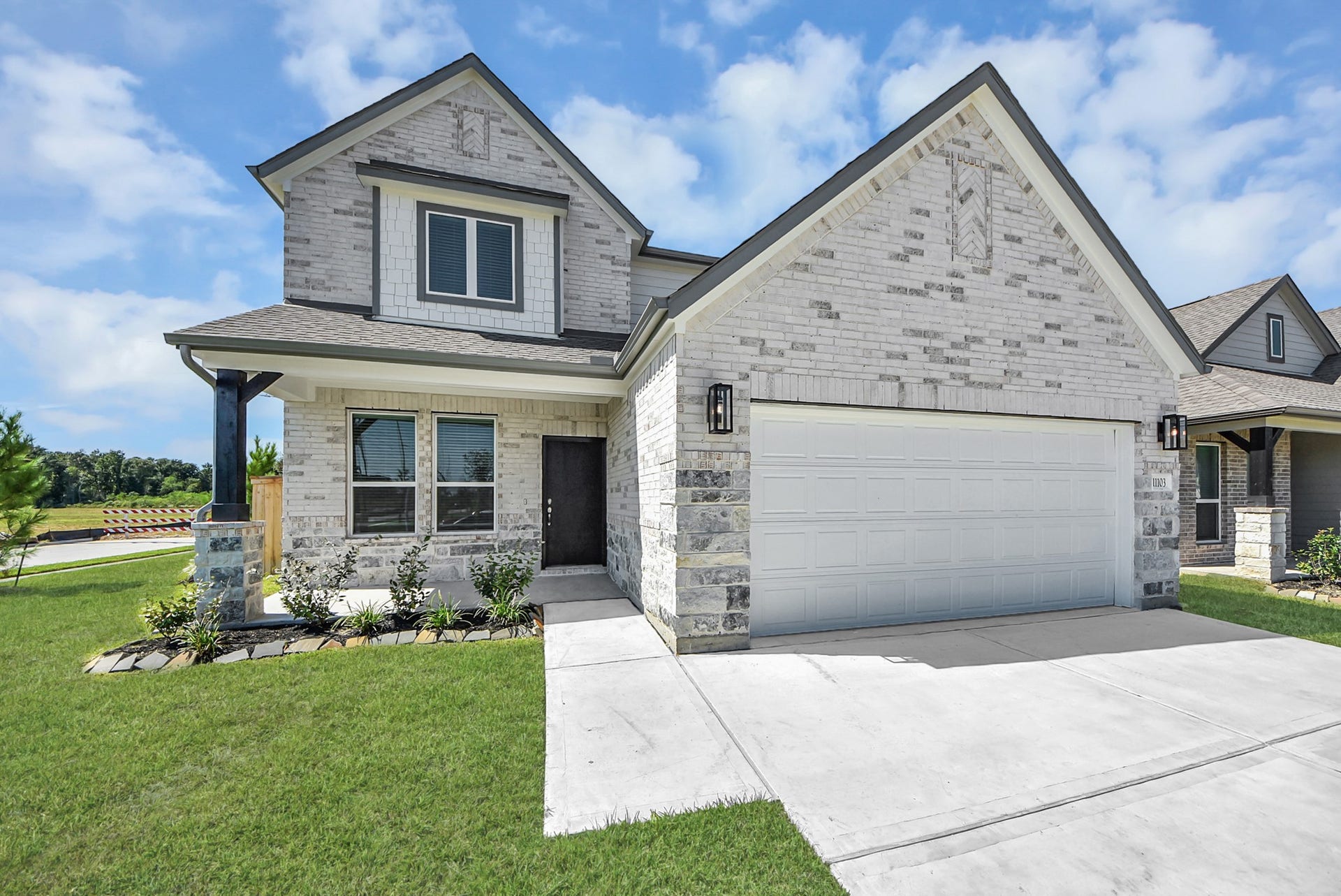 11103 Tulip Ridge Trail, Houston, TX 77044 The residence features a practical 2-car garage complemented by a generous driveway, ensuring abundant space for parking needs.
