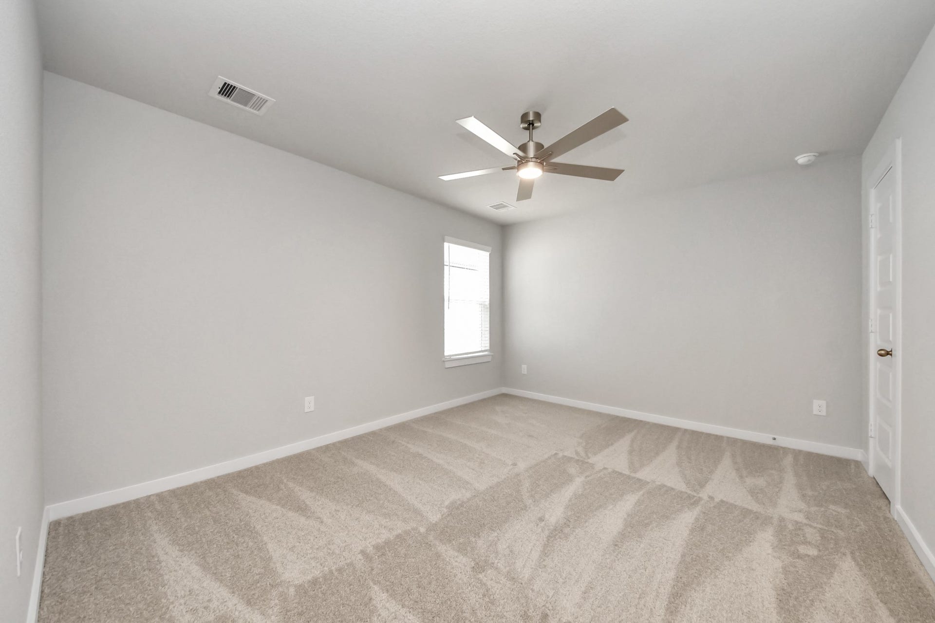 11103 Tulip Ridge Trail, Houston, TX 77044 Secondary bedroom features plush carpeting, large windows that let in plenty of natural light, bright paint, and spacious closets. Sample photo of completed home with similar floor plan. Actual colors and selections may vary.