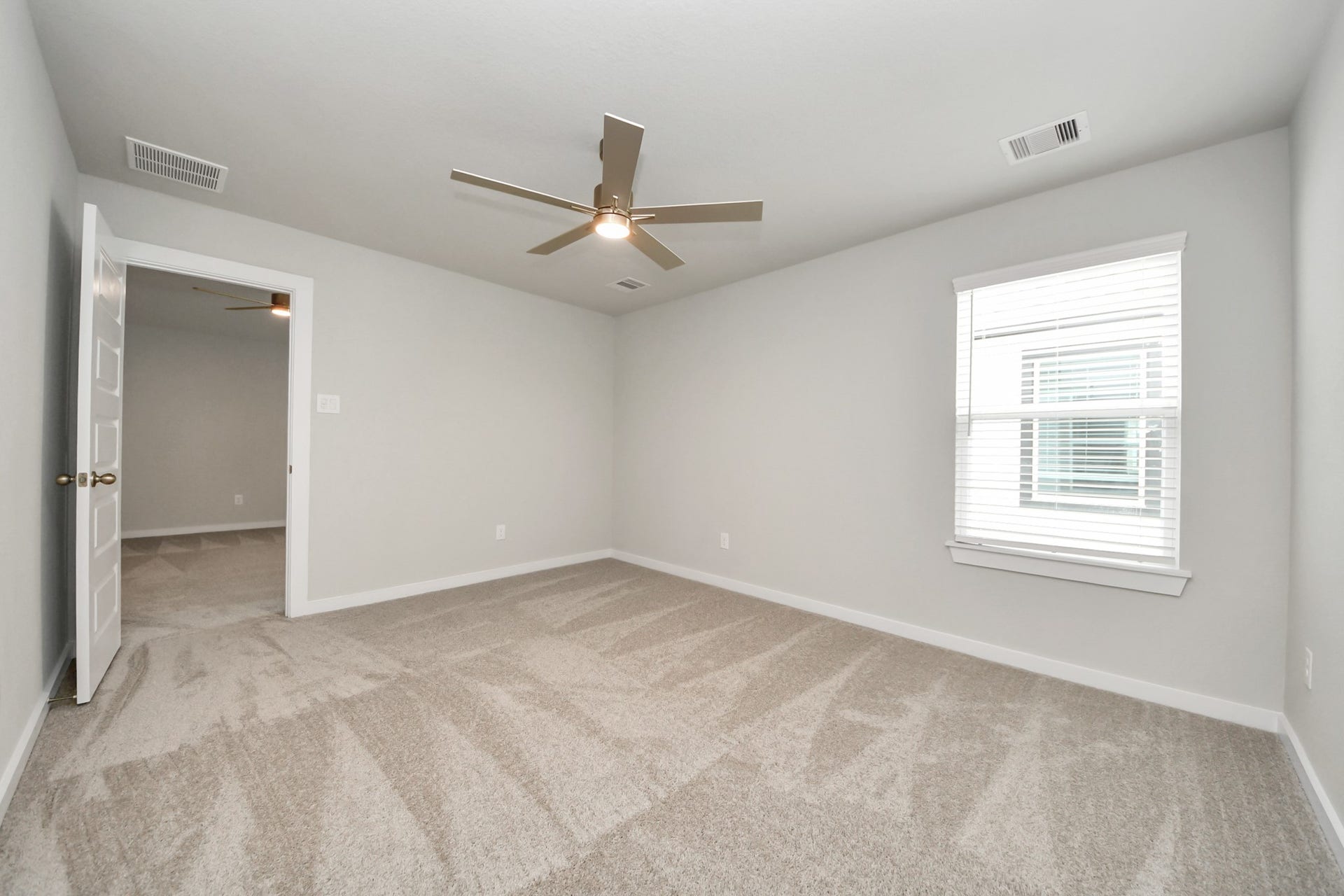 11103 Tulip Ridge Trail, Houston, TX 77044 Generously sized secondary bedrooms featuring spacious closets, soft and inviting carpeting underfoot, large windows allowing plenty of natural light, and the added touch of privacy blinds for your personal retreat. Sample photo of completed home with similar floor plan. Actual colors and selections may vary.