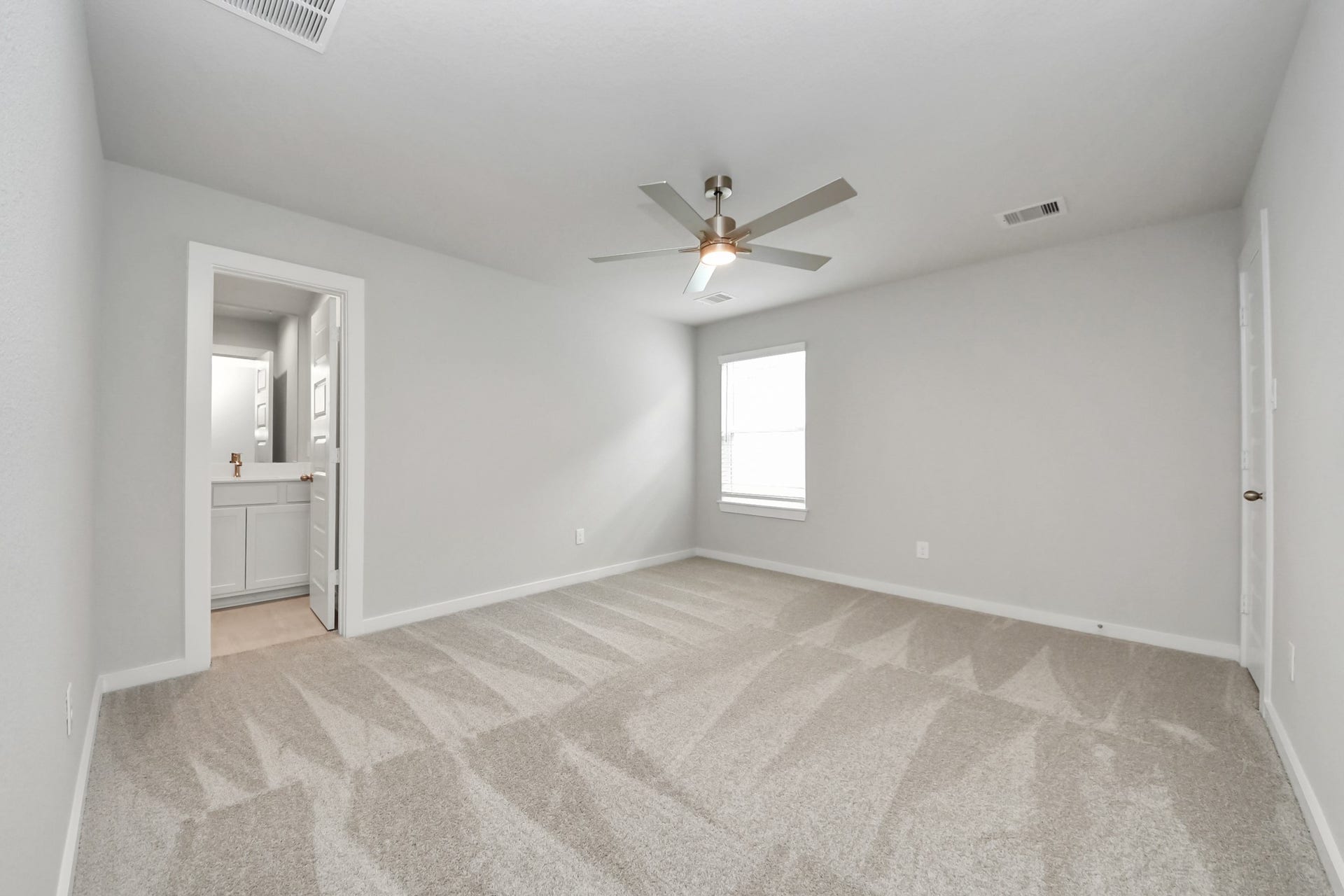 11103 Tulip Ridge Trail, Houston, TX 77044 Secondary bedroom features plush carpeting, large windows that let in plenty of natural light, bright paint, and spacious closets. Sample photo of completed home with similar floor plan. Actual colors and selections may vary.
