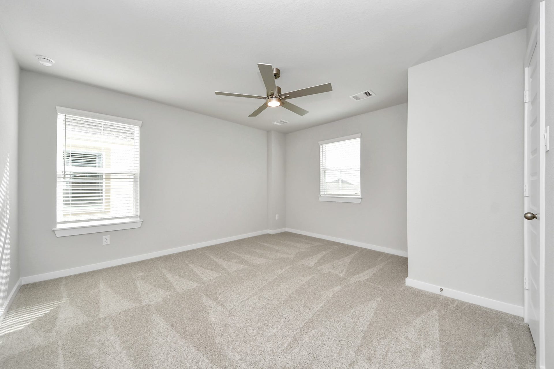 11103 Tulip Ridge Trail, Houston, TX 77044 Secondary bedroom features plush carpeting, large windows that let in plenty of natural light, bright paint, and spacious closets. Sample photo of completed home with similar floor plan. Actual colors and selections may vary.