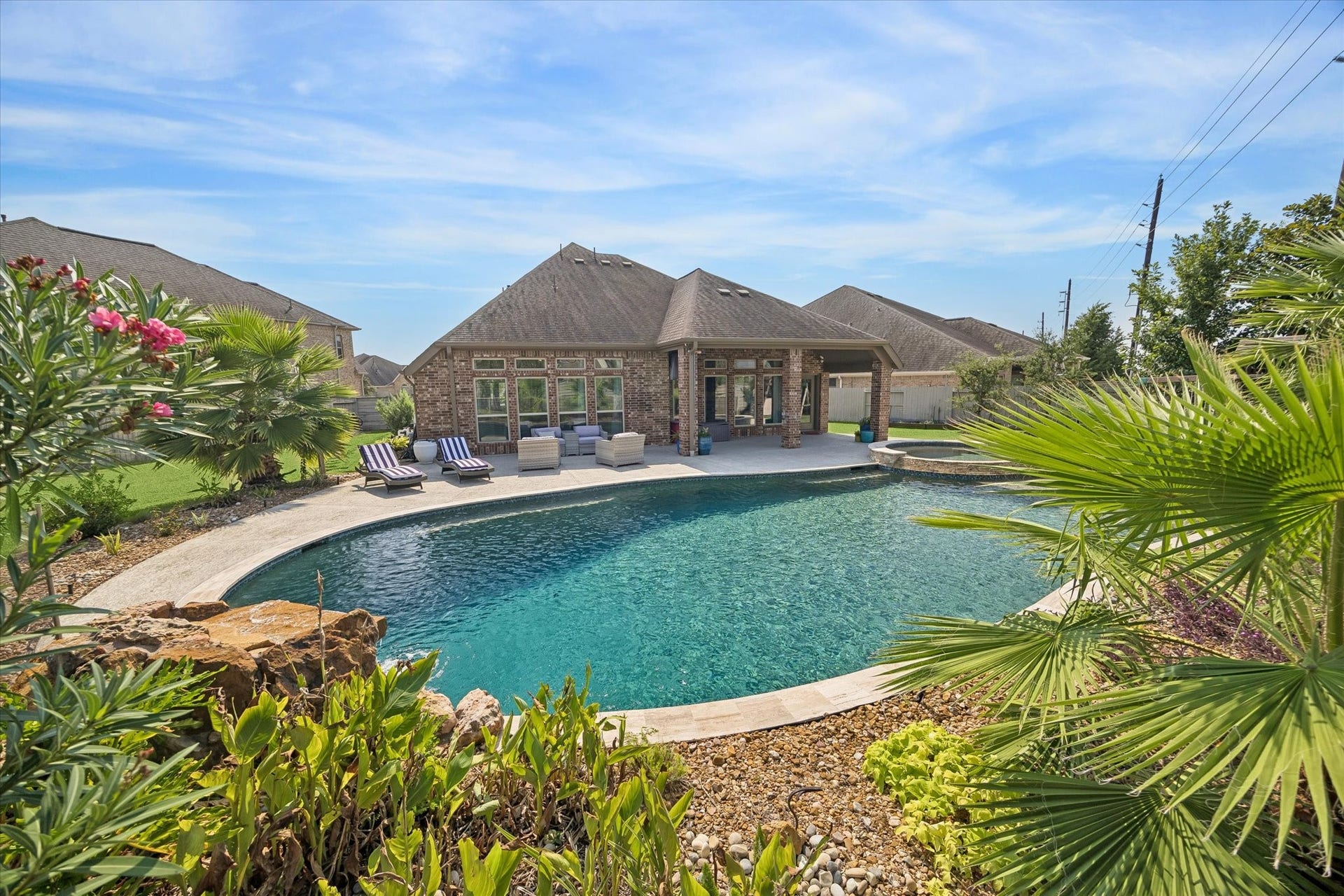 Here you can see the jumping ledge and waterfall feature facing the back porch. The pool is 10 feet in the deepest section!