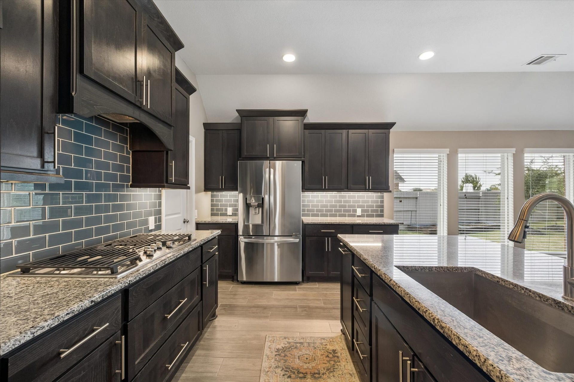 The beautiful backsplash offers a touch of color to this classic kitchen design.