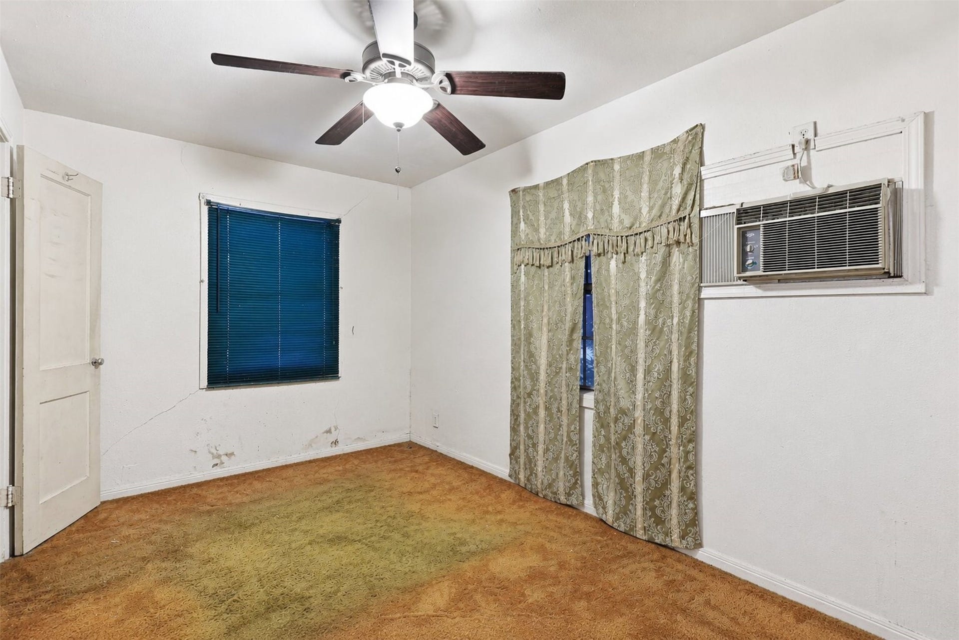 This bedroom offers a simple layout with plenty of potential to refresh and personalize