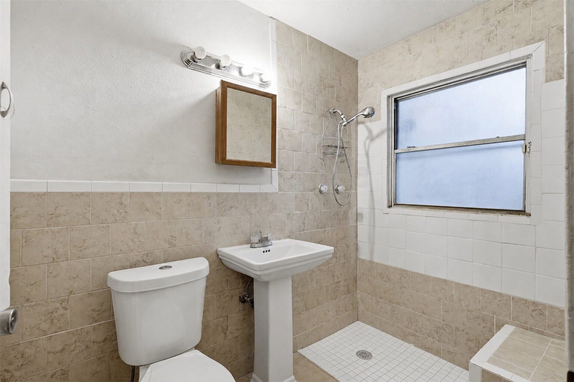Clean and practical bathroom space with walk-in shower design