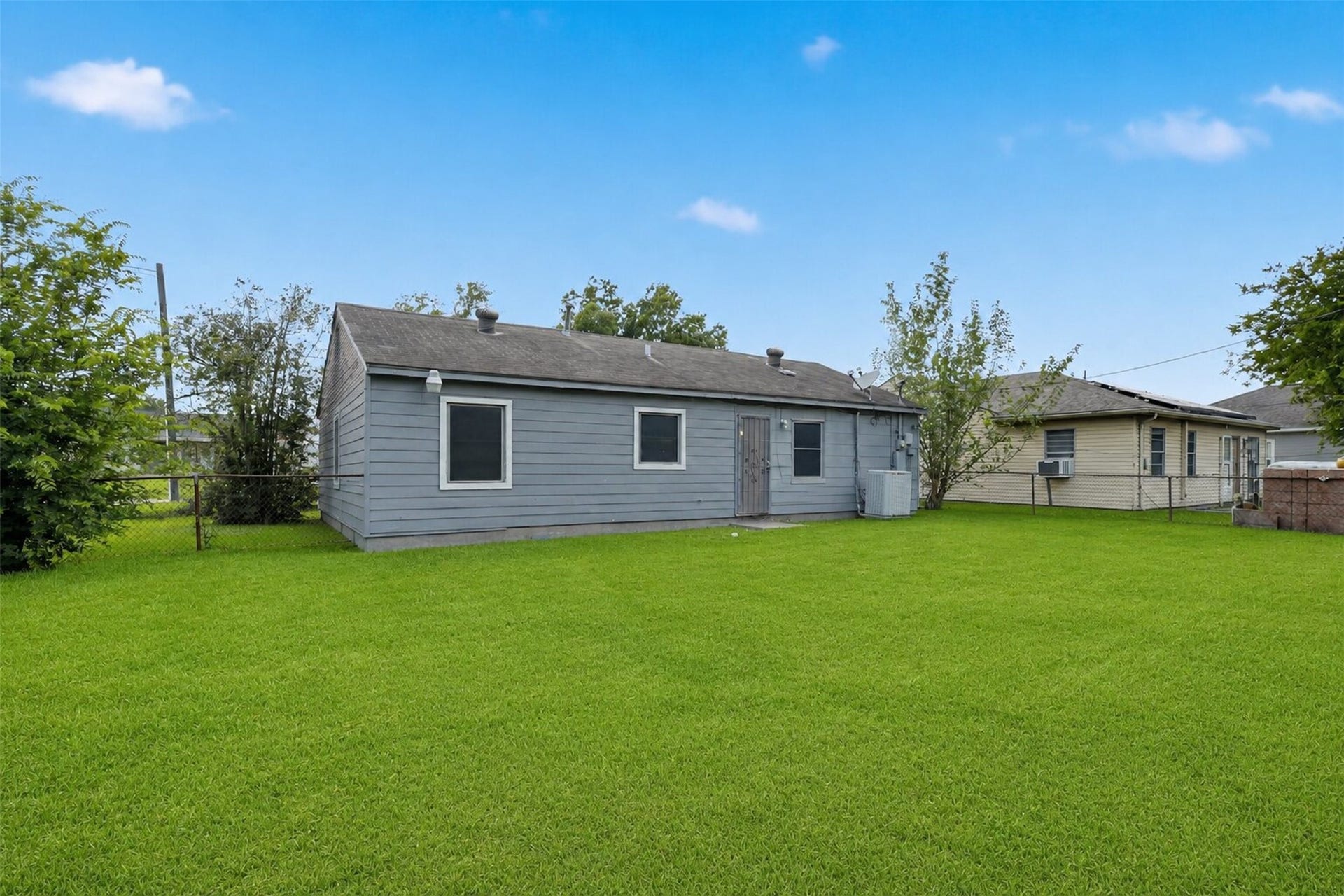 Large backyard ready for pets, gatherings, gardening, or play