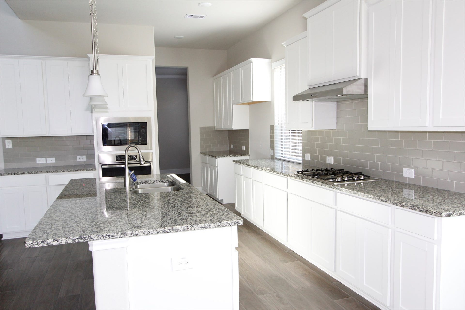 906 Daffodil View Court Court, Richmond, TX 77406 Open kitchen concept with a spectacular matching countertop, cabinets and cooktop
