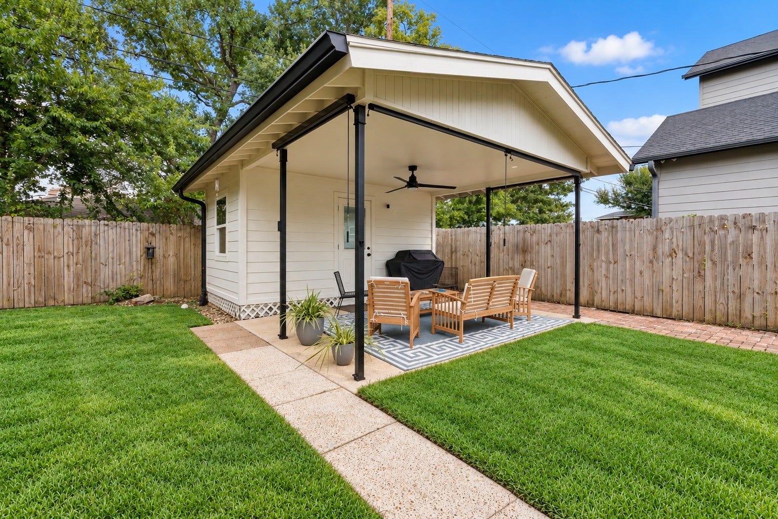 Tucked into the backyard, this detached office creates a dedicated work from home retreat while keeping you just steps from the main house. A covered patio extends the space outdoors for an easy transition from workday to downtime.