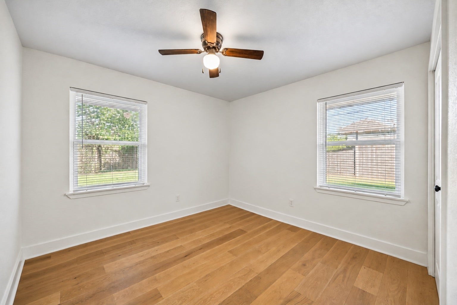 Bright and generously sized, this secondary bedroom offers two windows for natural light and plenty of room to create a comfortable retreat.