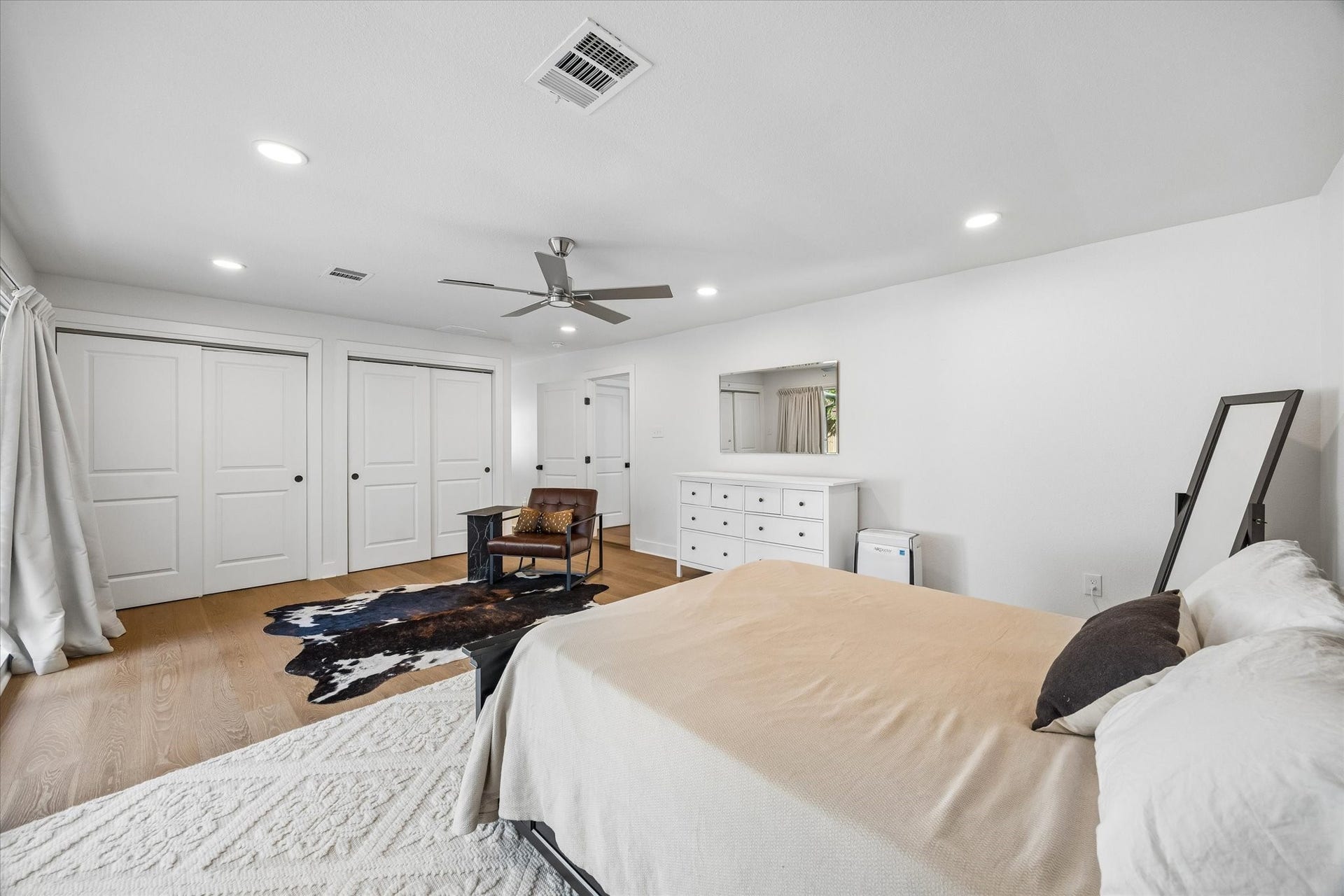Generous proportions continue with dual closets and a private hallway connecting the bedroom to the primary bath, plus direct backyard access for an easy indoor outdoor connection.