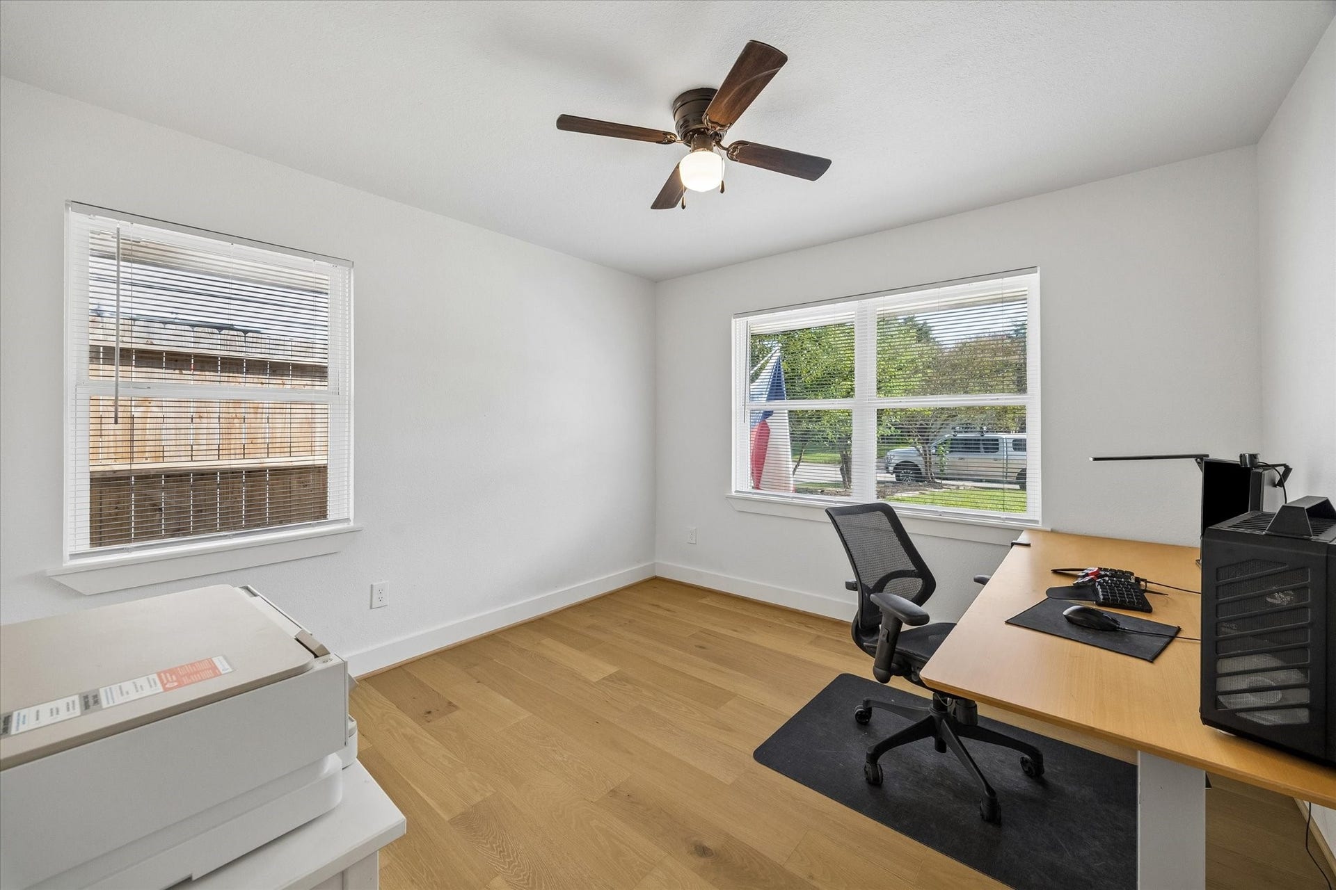 Currently serving as a home office, this secondary bedroom offers excellent flexibility with two large windows bringing in natural light and plenty of space for a full bedroom setup.