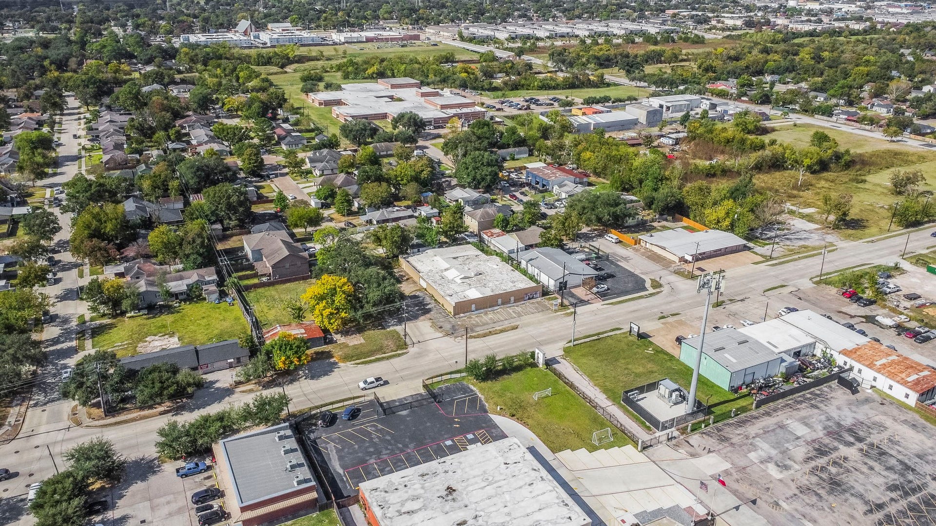 1018 Shaver Street, Pasadena, TX 77506 Aerial perspective highlighting proximity to nearby commercial, residential, and school zones.