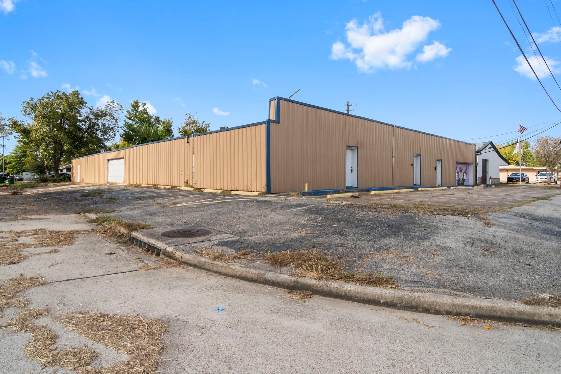 1018 Shaver Street, Pasadena, TX 77506 Side exterior view with multiple access doors and generous parking space.