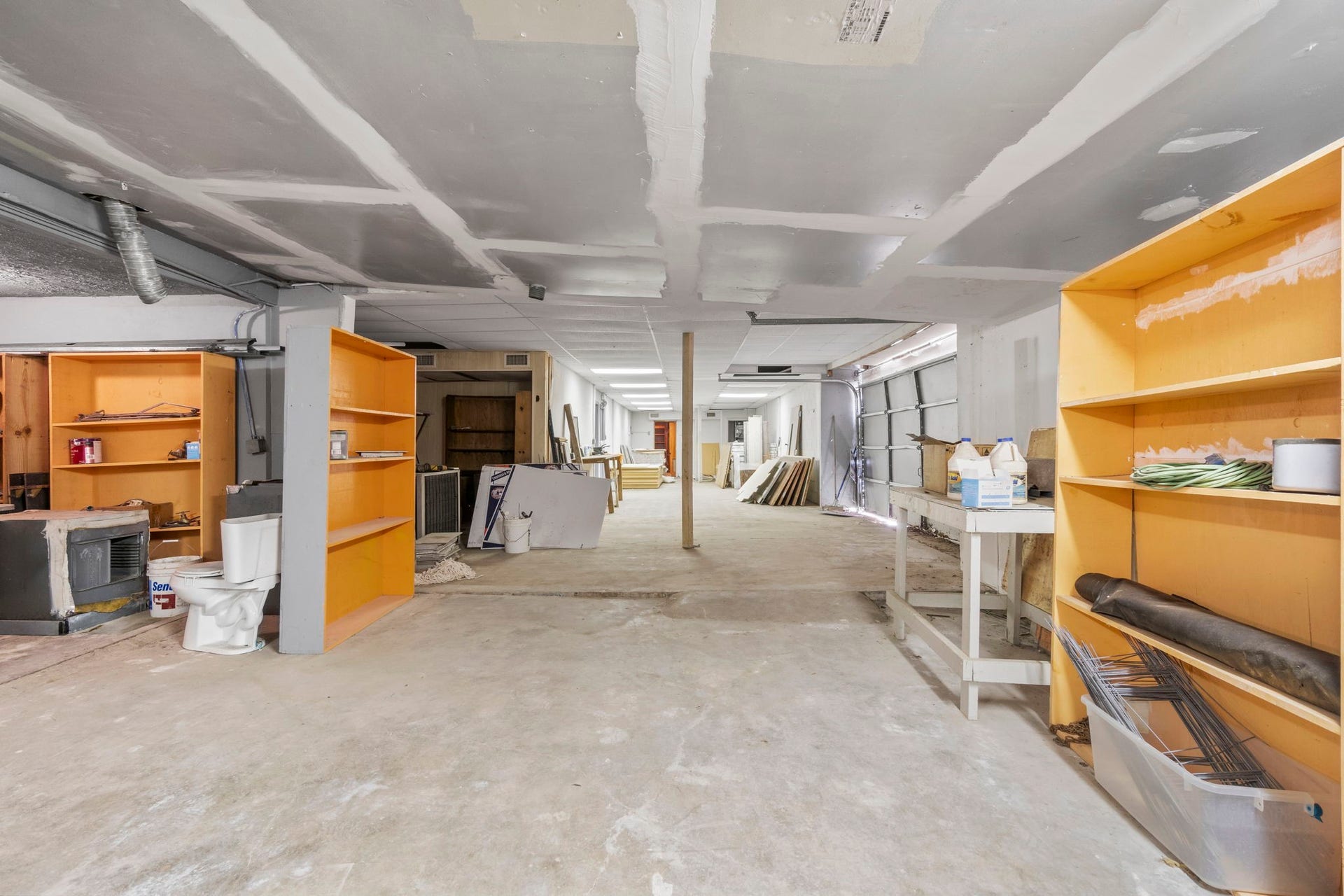 1018 Shaver Street, Pasadena, TX 77506 Large workshop or storage area with open floor plan and shelving.