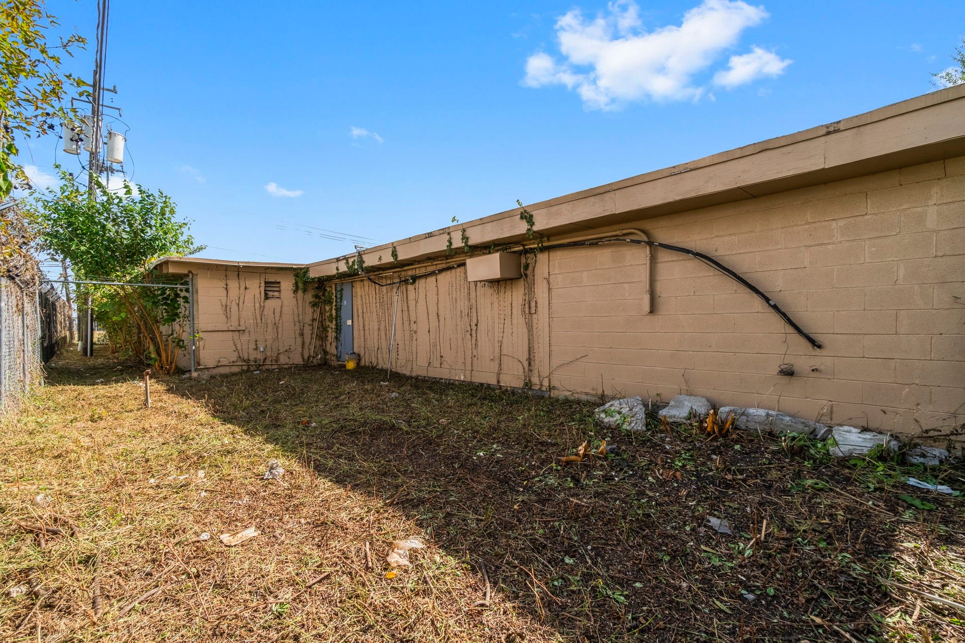 1018 Shaver Street, Pasadena, TX 77506 Secure rear exterior with gated access and utility connections