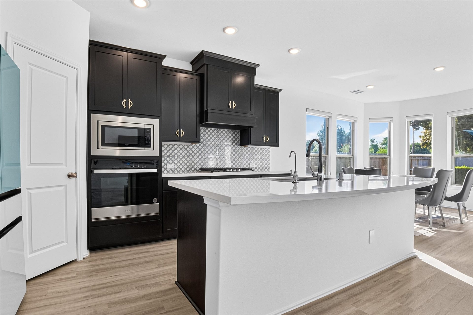 1315 Munson Valley Road, Richmond, TX 77406 Spacious center island with sleek countertops and a convenient built-in sink.