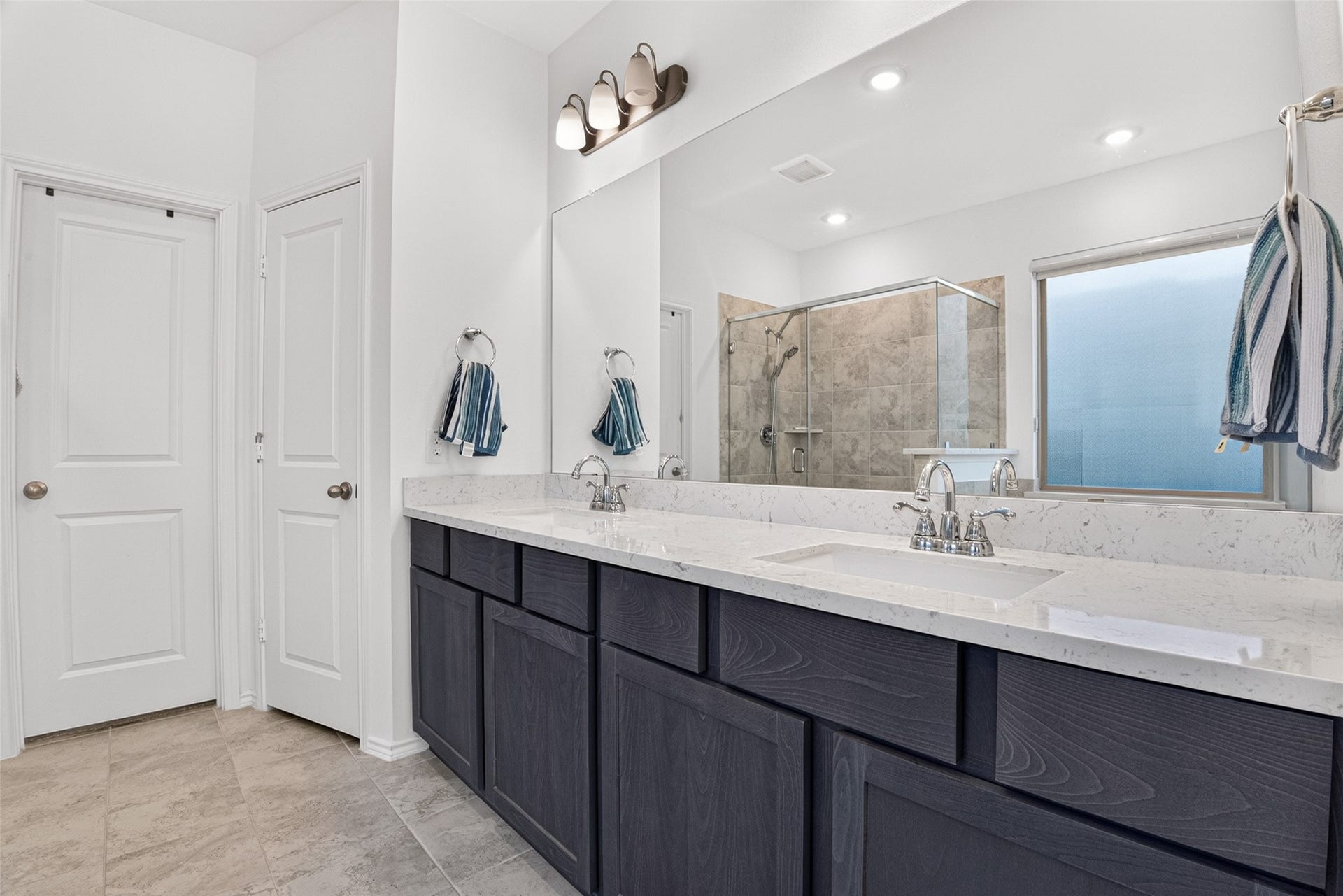 1315 Munson Valley Road, Richmond, TX 77406 Beautiful en-suite bath showcasing dark wood cabinetry and stylish chrome fixtures.