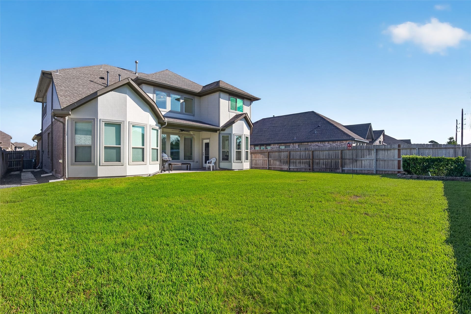 1315 Munson Valley Road, Richmond, TX 77406 Impressive backyard showcases a well-maintained lawn, attractive landscaping, and plenty of open space for outdoor enjoyment.
