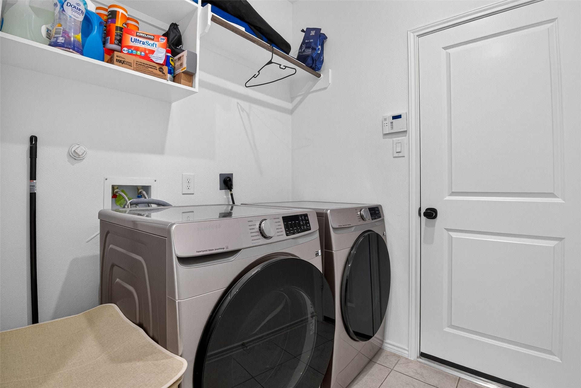 1315 Munson Valley Road, Richmond, TX 77406 Functional laundry area with built-in overhead shelving for additional storage.
