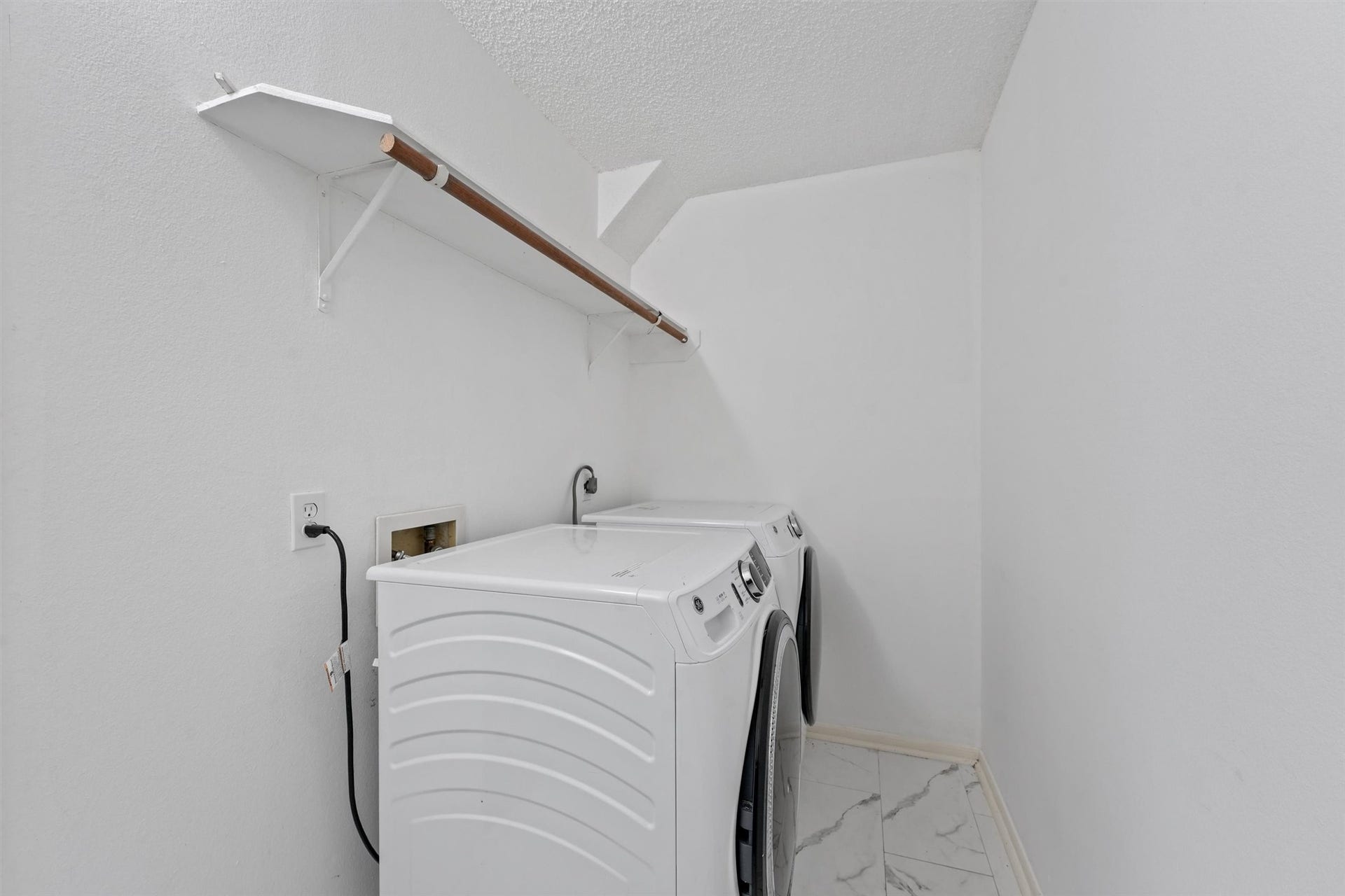 laundry room equipped with a modern washer and dryer