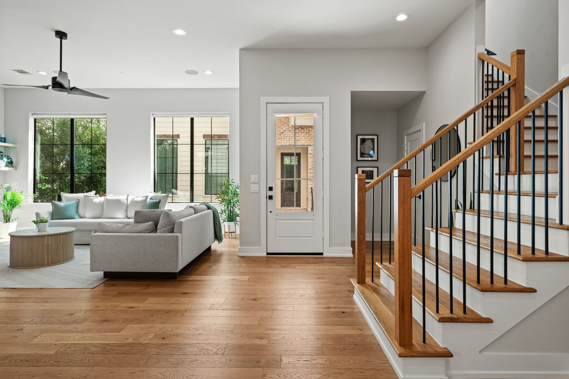 733 E 10th 1/2 Street, Houston, TX 77008 Natural light fills the gracious first-floor entry, where wide-plank white oak flooring begins a cohesive interior palette. The open staircase introduces the home's clean architectural detailing.
