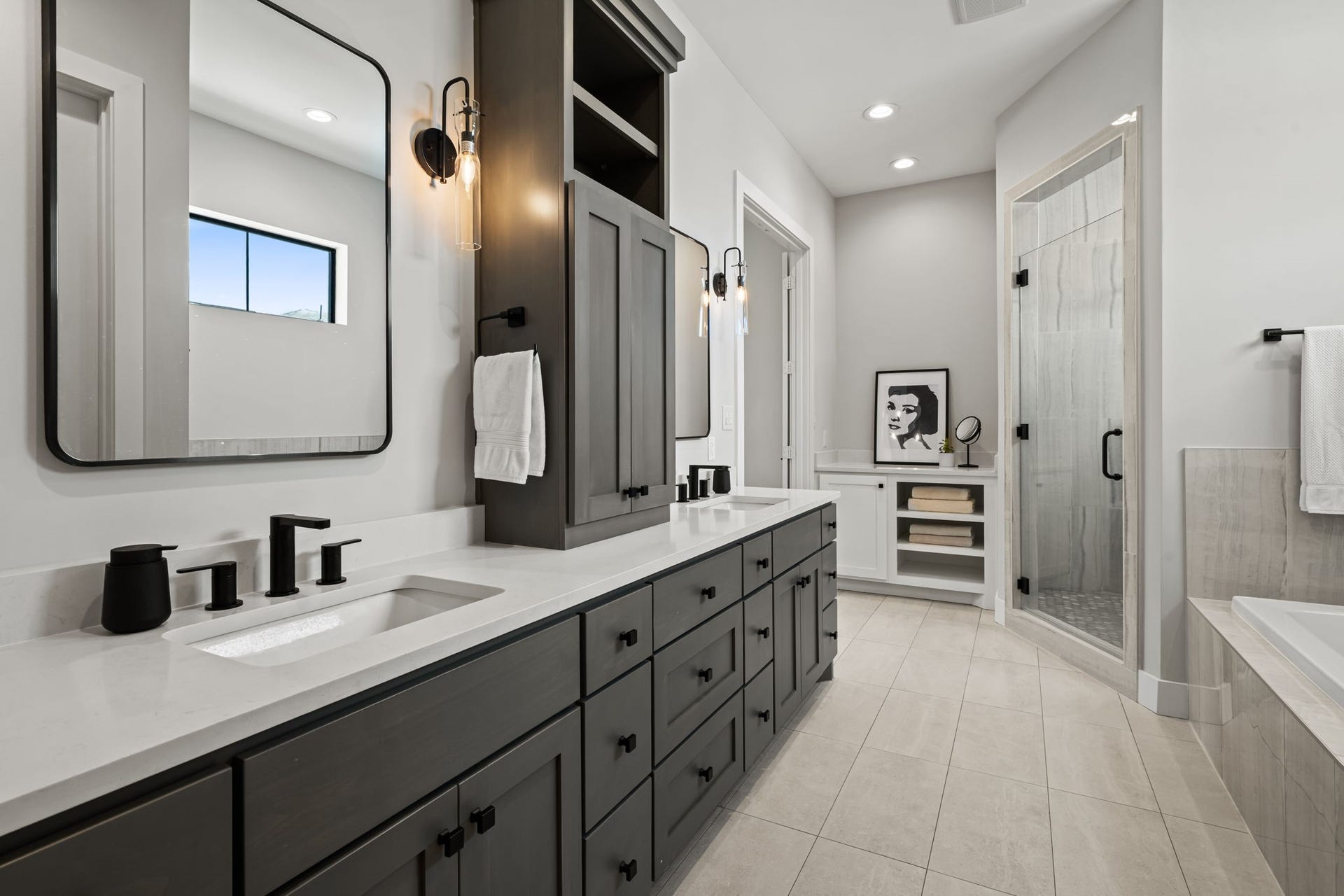 733 E 10th 1/2 Street, Houston, TX 77008 Dual sinks and a dedicated seated vanity provide generous personal space in the primary bath. Sleek fixtures and dimensional finishes balance beauty with practical storage.
