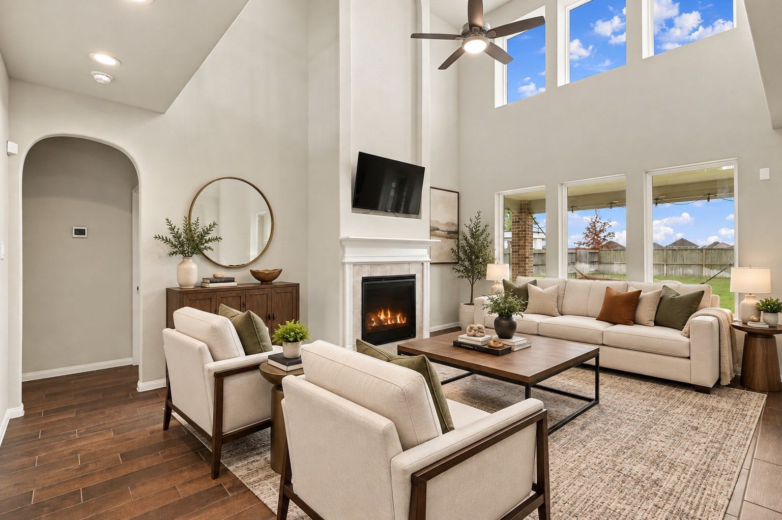 24115 Lake Molveno Drive, Katy, TX 77493 Virtually Staged: The spacious open plan comfortably fits large seating arrangements around a cozy tiled fireplace and central entertainment wall.