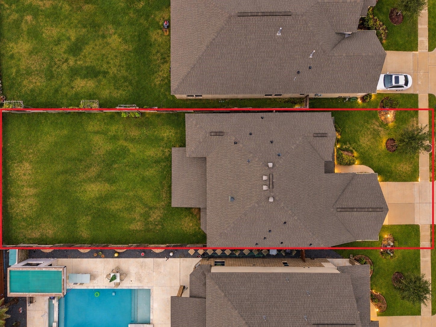 24115 Lake Molveno Drive, Katy, TX 77493 This aerial top-down view highlights the propertys generous plot dimensions, outlined by property lines to show the true scale of the lot.