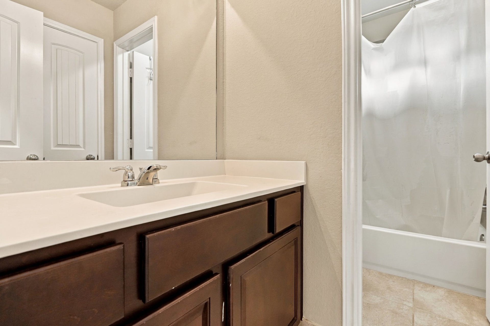 24115 Lake Molveno Drive, Katy, TX 77493 This well-designed secondary bathroom features a split layout that separates the vanity sink area from the private tub and shower combination.