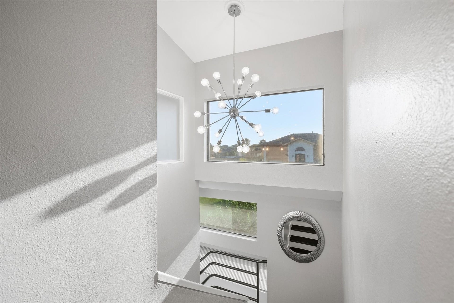 18217 Sandy Cove, Houston, TX 77058 Statement modern chandelier illuminating the upper landing.